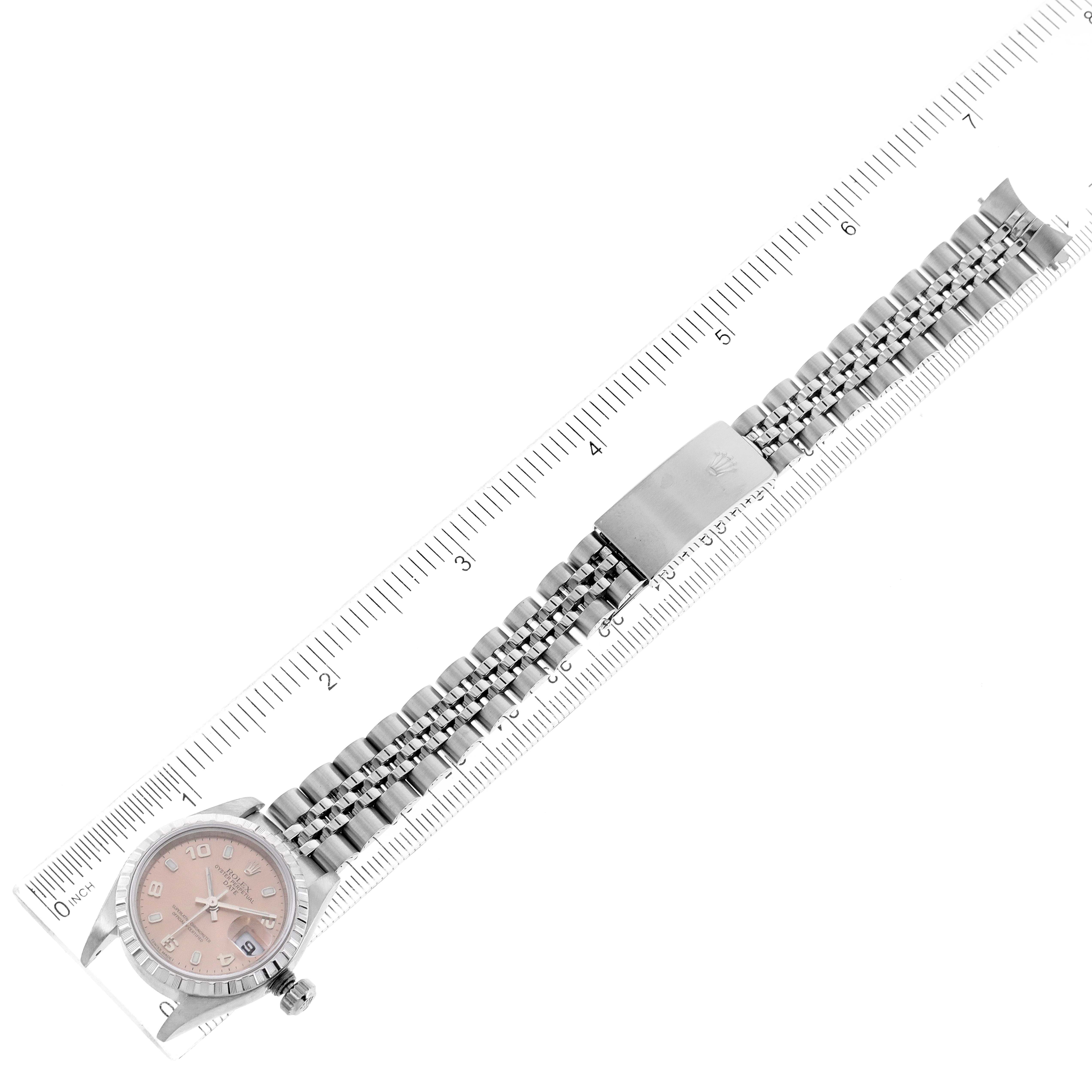 This image shows a Rolex Date 79240 Women's Stainless Steel Pink Dial 79240 Women's Stainless Steel Pink Dial model watch lying flat with a ruler for scale, displaying its face, bracelet, and clasp.