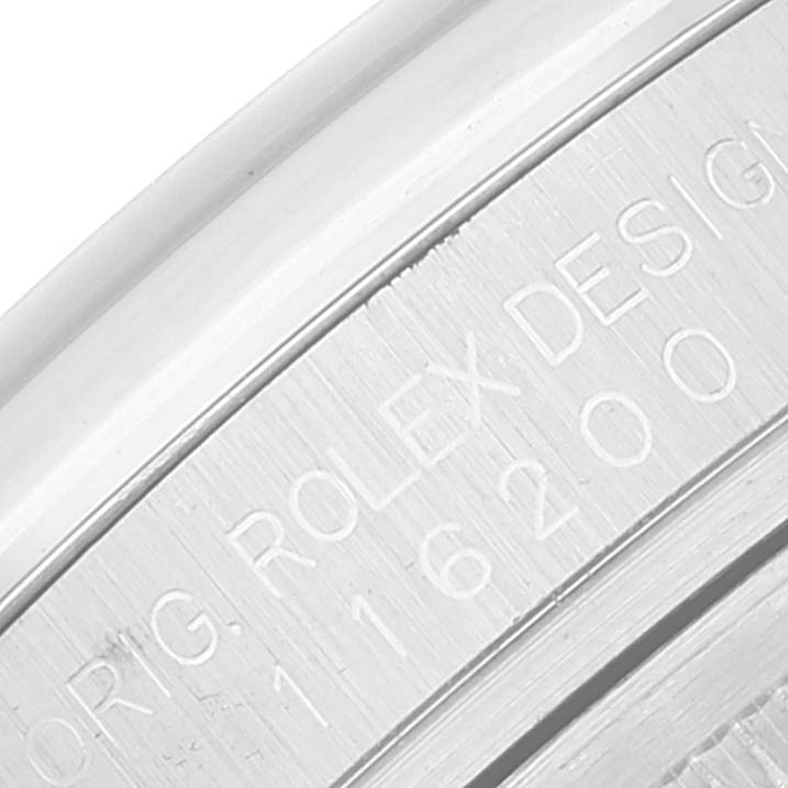 The image shows a close-up of the side engraving on the bezel of a Rolex Datejust 116200 Men's Stainless Steel Blue Dial 116200 Men's Stainless Steel Blue Dial model.