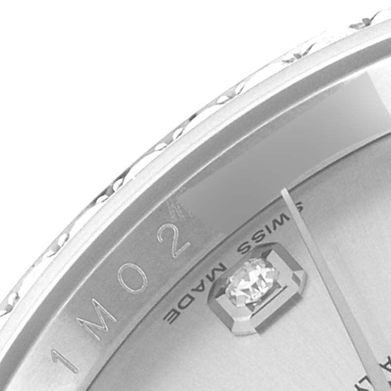 This close-up of a Rolex Datejust 116244 Men's Stainless Steel Silver Dial 116244 Men's Stainless Steel Silver Dial watch shows part of the dial with diamond markers and the "Swiss Made" inscription.