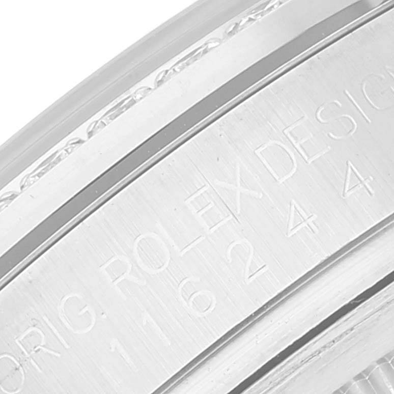 This is a close-up view of the inside watch case of a Rolex Datejust 116244 Men's Stainless Steel Silver Dial 116244 Men's Stainless Steel Silver Dial, showing engravings.