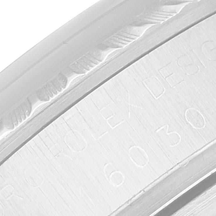 This image shows a close-up of the engraved serial number and design details on the side of a Rolex Vintage Collection 16030 Men's Stainless Steel Silver Dial 16030 Men's Stainless Steel Silver Dial watch.