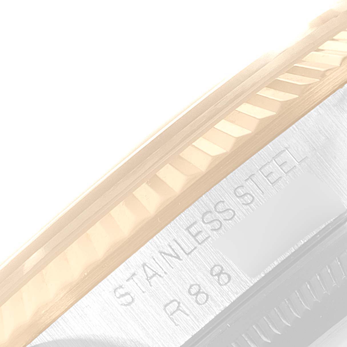 This image shows a close-up angle of the fluted bezel and part of the case with "STAINLESS STEEL" engraved on a Rolex Datejust 16233 Men
s Steel and Gold (two tone) Champagne Dial 16233 Men
s Steel and Gold (two tone) Champagne Dial watch.