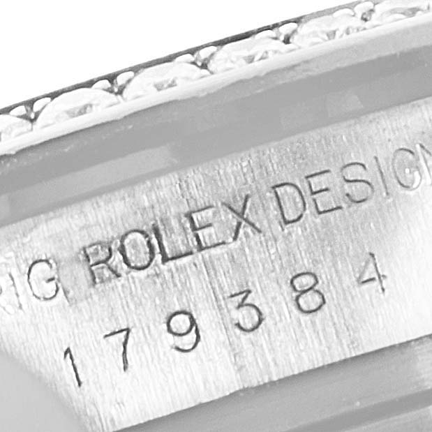 The image shows the engraved serial number and "ROLEX DESIGN" on the side of the case for a Rolex Datejust 179384 Women's Stainless Steel Silver Dial 179384 Women's Stainless Steel Silver Dial model.