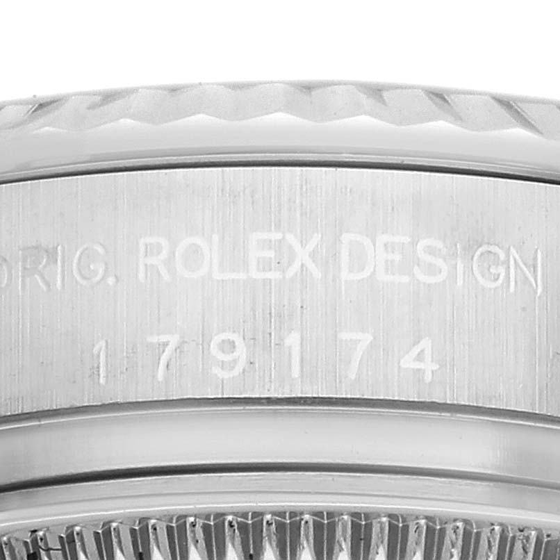 The image shows a close-up of the case side and bezel of a Rolex Datejust 179174 Women's Stainless Steel Silver Dial 179174 Women's Stainless Steel Silver Dial watch, featuring the brand engravings.