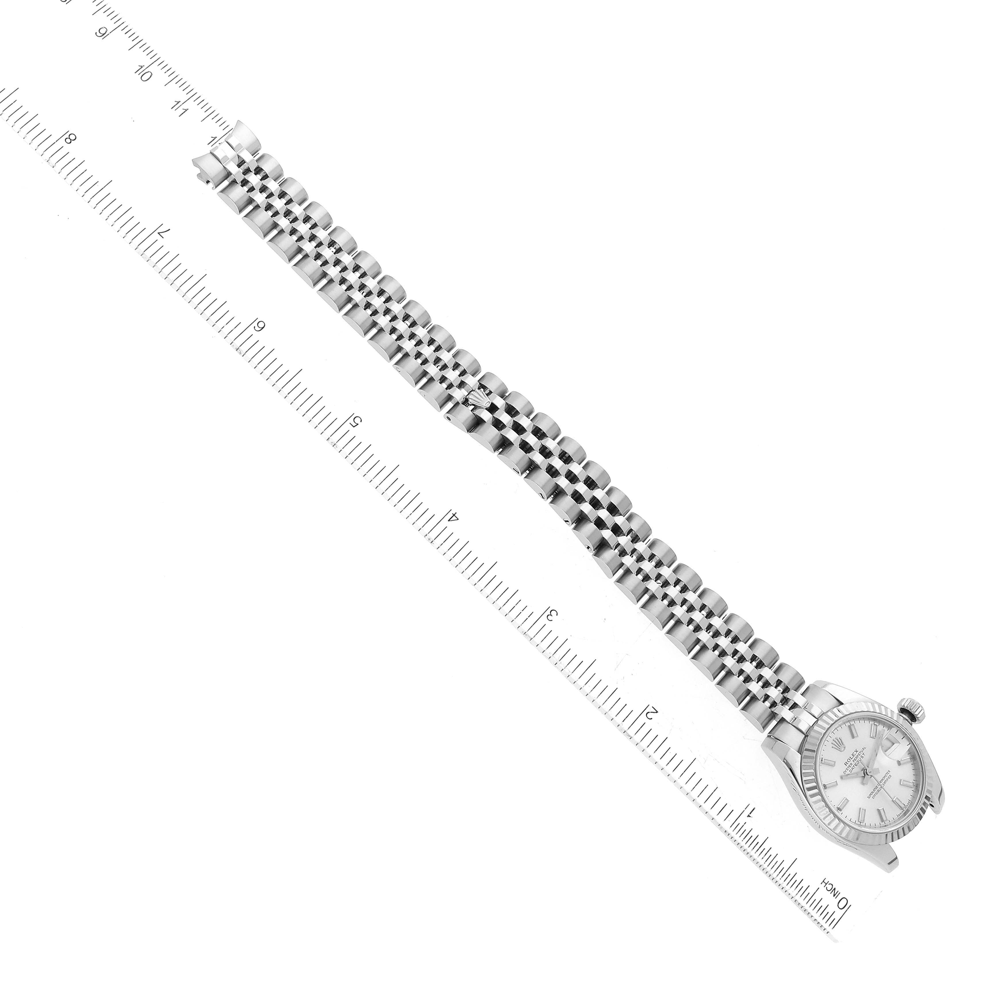 The image shows a Rolex Datejust 179174 Women's Stainless Steel Silver Dial 179174 Women's Stainless Steel Silver Dial watch at a diagonal angle, highlighting its face and bracelet alongside a ruler.