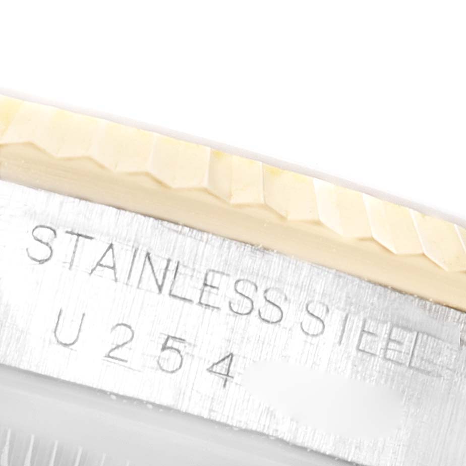 This close-up image shows the engraved bezel and part of the casing of the Rolex Datejust 16233 Men's Steel and Gold (two tone) Mother of Pearl Dial 16233 Men's Steel and Gold (two tone) Mother of Pearl Dial watch.