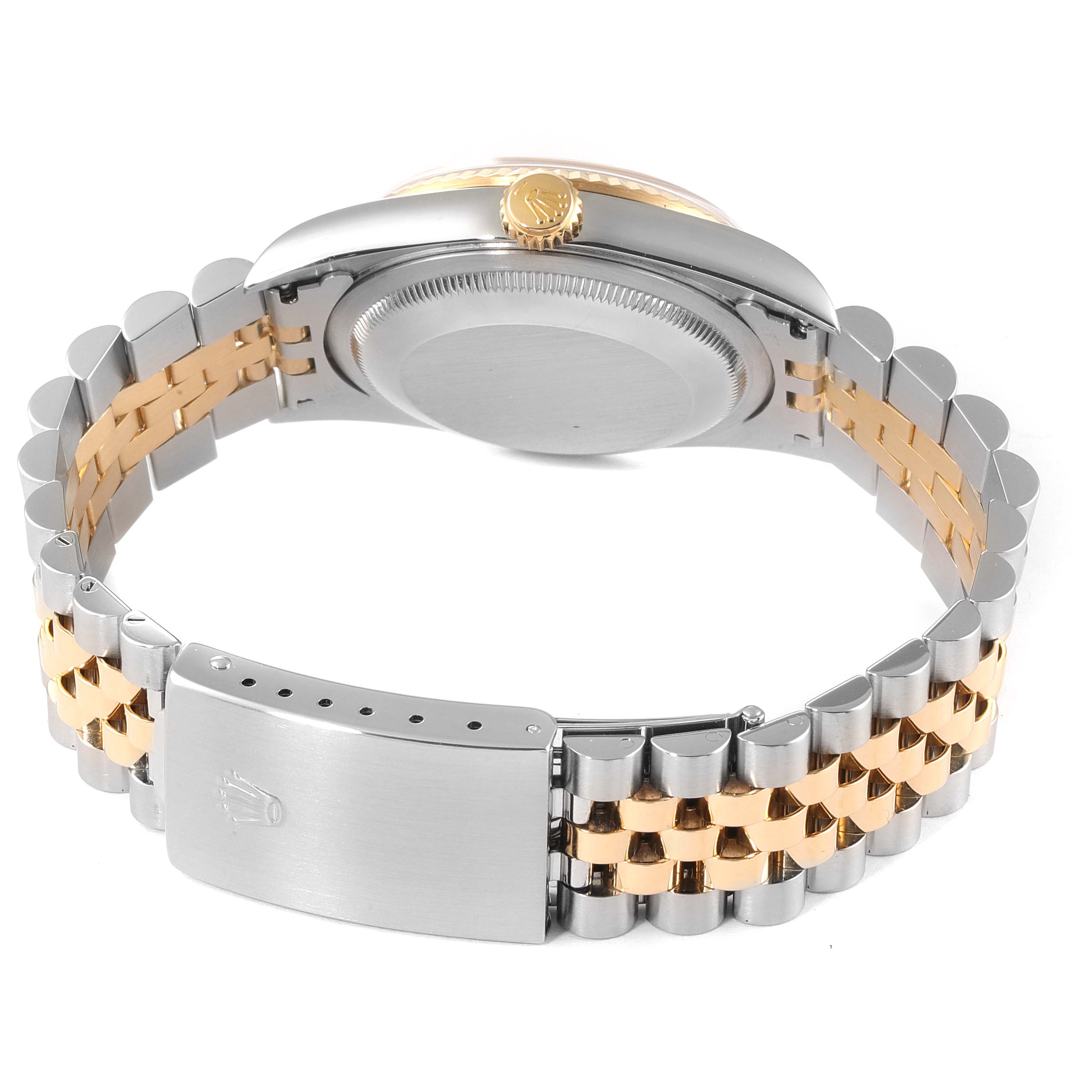 This image shows the back view of the Rolex Datejust 16233 Men's Steel and Gold (two tone) Mother of Pearl Dial 16233 Men's Steel and Gold (two tone) Mother of Pearl Dial watch, highlighting its clasp, bracelet, and crown.