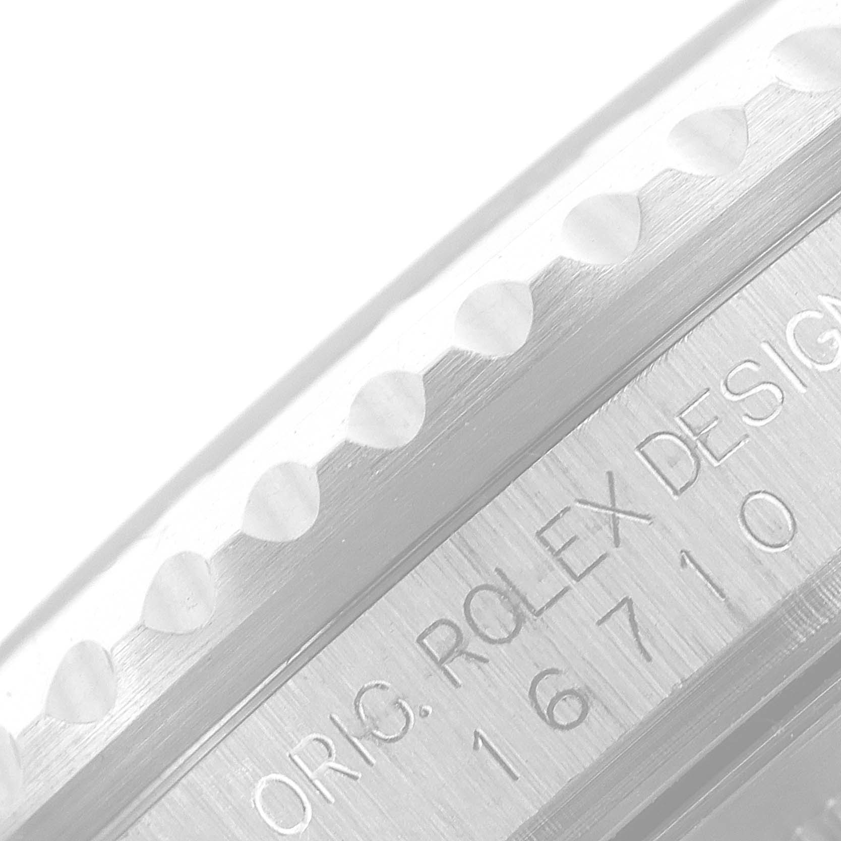 The image shows a close-up of the engraved case and bezel of a Rolex GMT-Master 16710 Men
s Stainless Steel Black Dial 16710 Men
s Stainless Steel Black Dial watch, featuring the model number 16710.