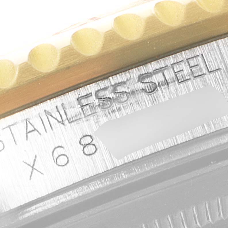 The image shows a close-up of the side of a Rolex GMT-Master 16713 Men's Steel and Gold (two tone) Grey Dial 16713 Men's Steel and Gold (two tone) Grey Dial watch, highlighting the stainless steel bezel engraving.