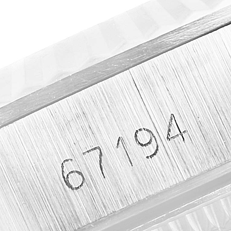This close-up angle showcases the engraved serial number "67194" on the case of the Rolex Oyster Perpetual 67194 Women's Stainless Steel Silver Dial 67194 Women's Stainless Steel Silver Dial watch.