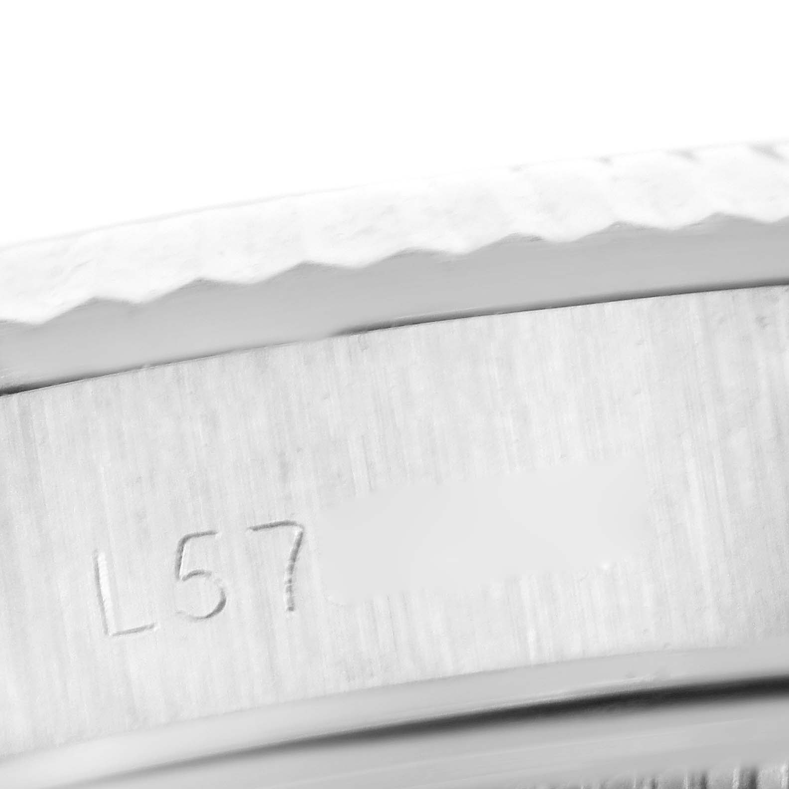 This close-up image shows the engraved serial number on the side of the casing of a Rolex Oyster Perpetual 67194 Women's Stainless Steel Silver Dial 67194 Women's Stainless Steel Silver Dial watch.