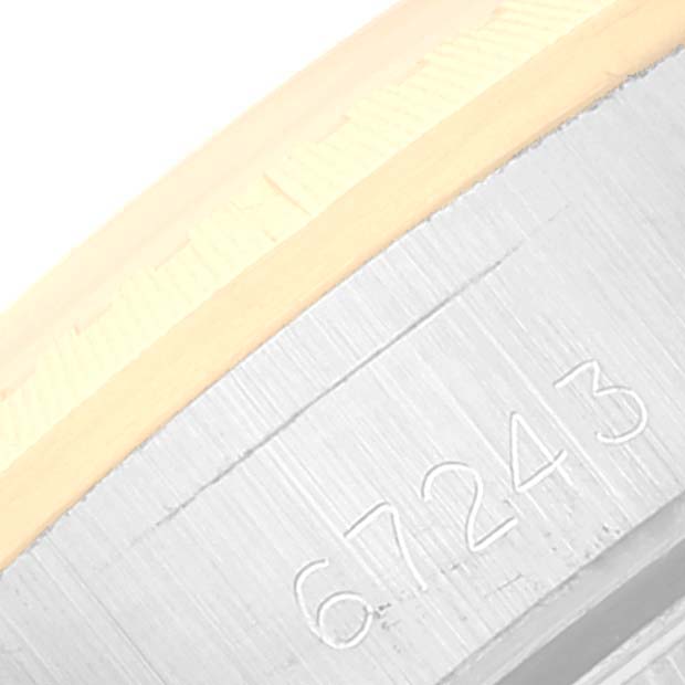 The image shows a close-up of the serial number on the side of the bezel of a Rolex Oyster Perpetual 67243 Women's Steel and Gold (two tone) Champagne Dial 67243 Women's Steel and Gold (two tone) Champagne Dial watch.