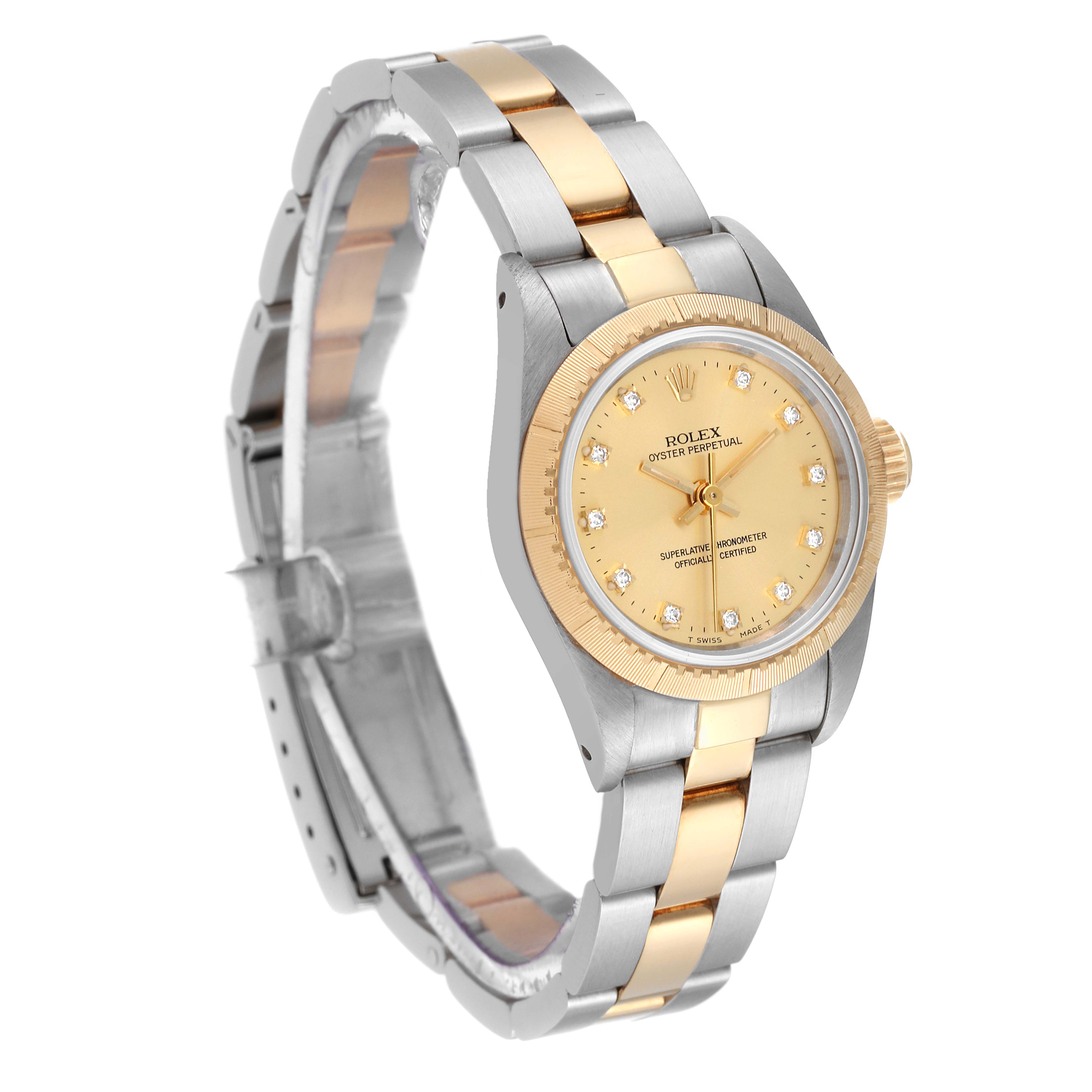 This Rolex Oyster Perpetual 67243 Women's Steel and Gold (two tone) Champagne Dial 67243 Women's Steel and Gold (two tone) Champagne Dial watch is shown at an angle displaying the face, bezel, and bracelet in a two-tone metal finish.