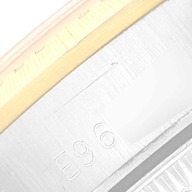 This image shows a close-up view of the bezel and part of the case of the Rolex Oyster Perpetual 67243 Women's Steel and Gold (two tone) Champagne Dial 67243 Women's Steel and Gold (two tone) Champagne Dial watch.