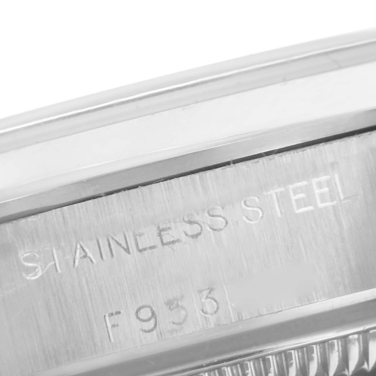 The image shows the engraved serial number and "STAINLESS STEEL" marking on the case side of a Rolex Oyster Perpetual 76080 Women
s Stainless Steel Pink Dial 76080 Women
s Stainless Steel Pink Dial watch.