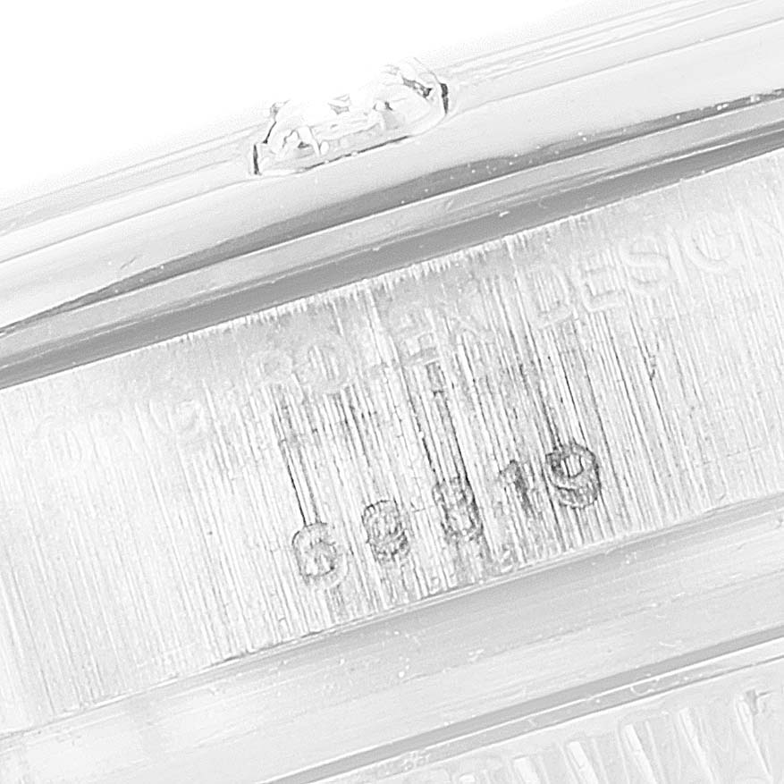 The image shows a close-up of the serial number and model engraving on the side of the Rolex Pearlmaster 69319 Women's White Gold Silver Dial 69319 Women's White Gold Silver Dial watch case.