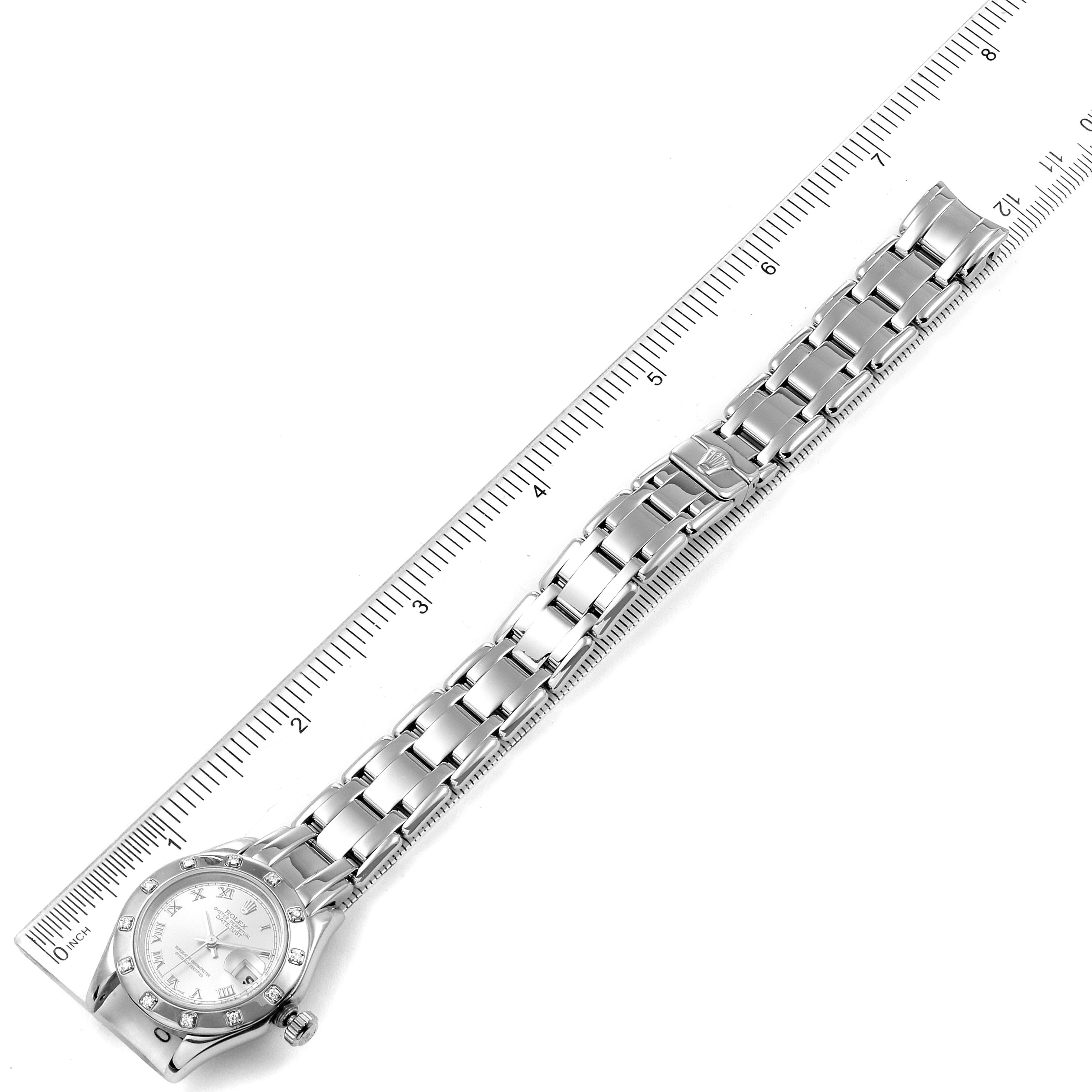 The image shows a top-down view of a Rolex Pearlmaster 69319 Women's White Gold Silver Dial 69319 Women's White Gold Silver Dial watch laid next to a ruler for scale.
