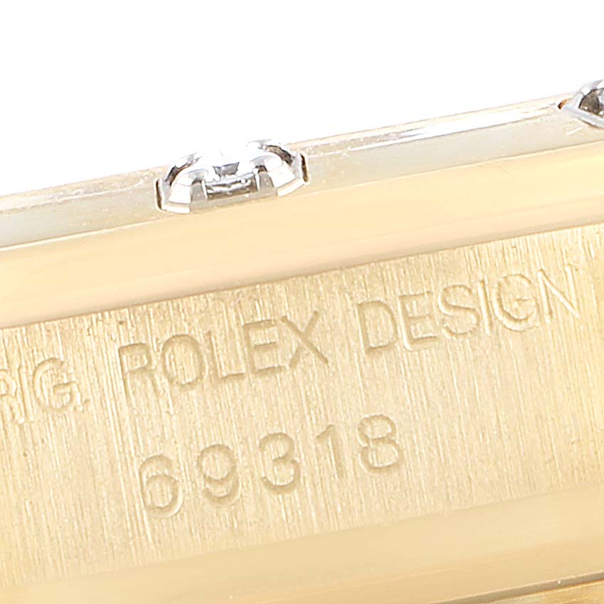 This image shows a close-up of the side and bracelet link area of a Rolex Pearlmaster 69318 Women's Yellow Gold White Dial 69318 Women's Yellow Gold White Dial watch, highlighting the engraved model number 69318.