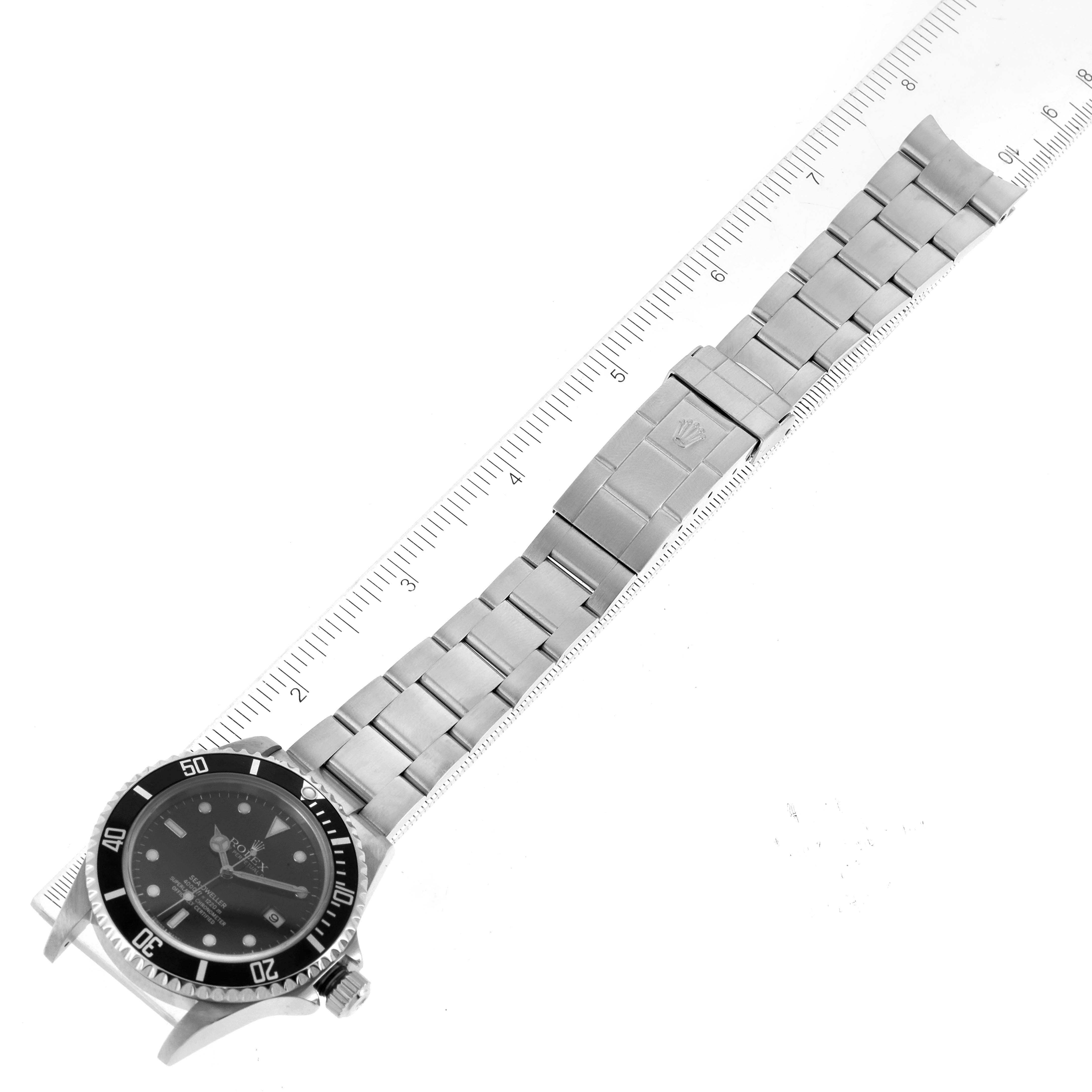 The image shows a top view of a Rolex Sea-Dweller 16600 Men
s Stainless Steel Black Dial 16600 Men
s Stainless Steel Black Dial watch with its full stainless steel bracelet and clasp.