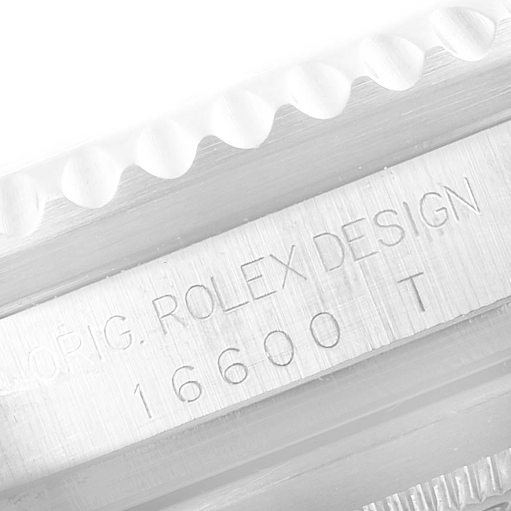 This close-up image shows the bezel edge and the engraved model number "16600" of a Rolex Sea-Dweller 16600 Men
s Stainless Steel Black Dial 16600 Men
s Stainless Steel Black Dial watch.