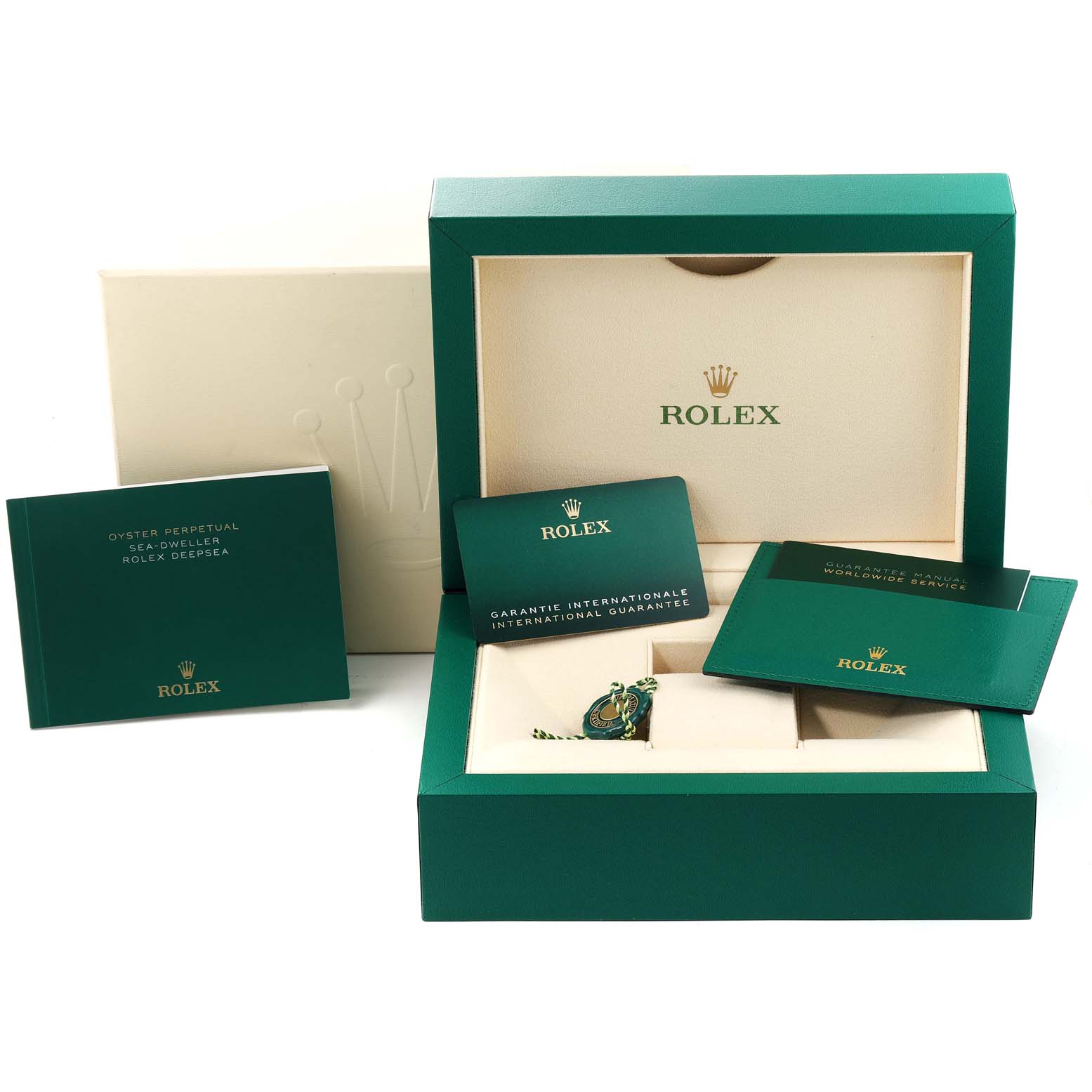 The image shows the packaging and accessories for the Rolex Sea-Dweller 126660 Men
s Stainless Steel Blue Dial 126660 Men
s Stainless Steel Blue Dial watch, including a green box and booklets.