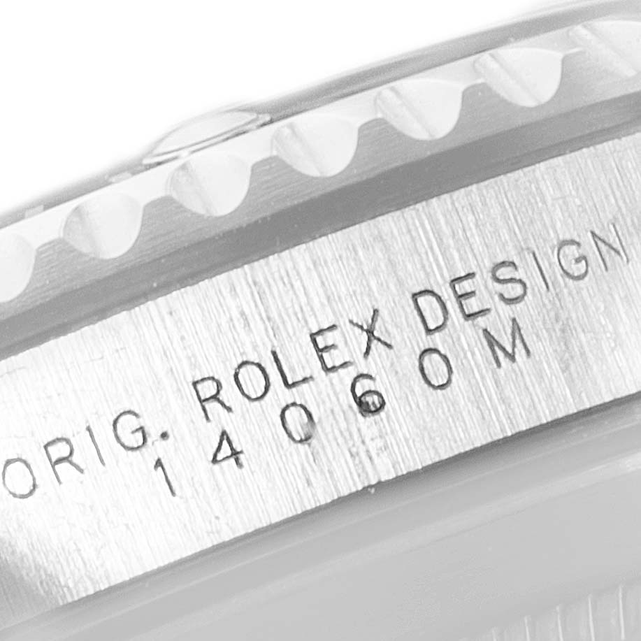 The image shows a close-up of the side of a Rolex Submariner 14060 Men
s Stainless Steel Black Dial 14060 Men
s Stainless Steel Black Dial watch case, highlighting the engraved "Rolex Design 14060M".