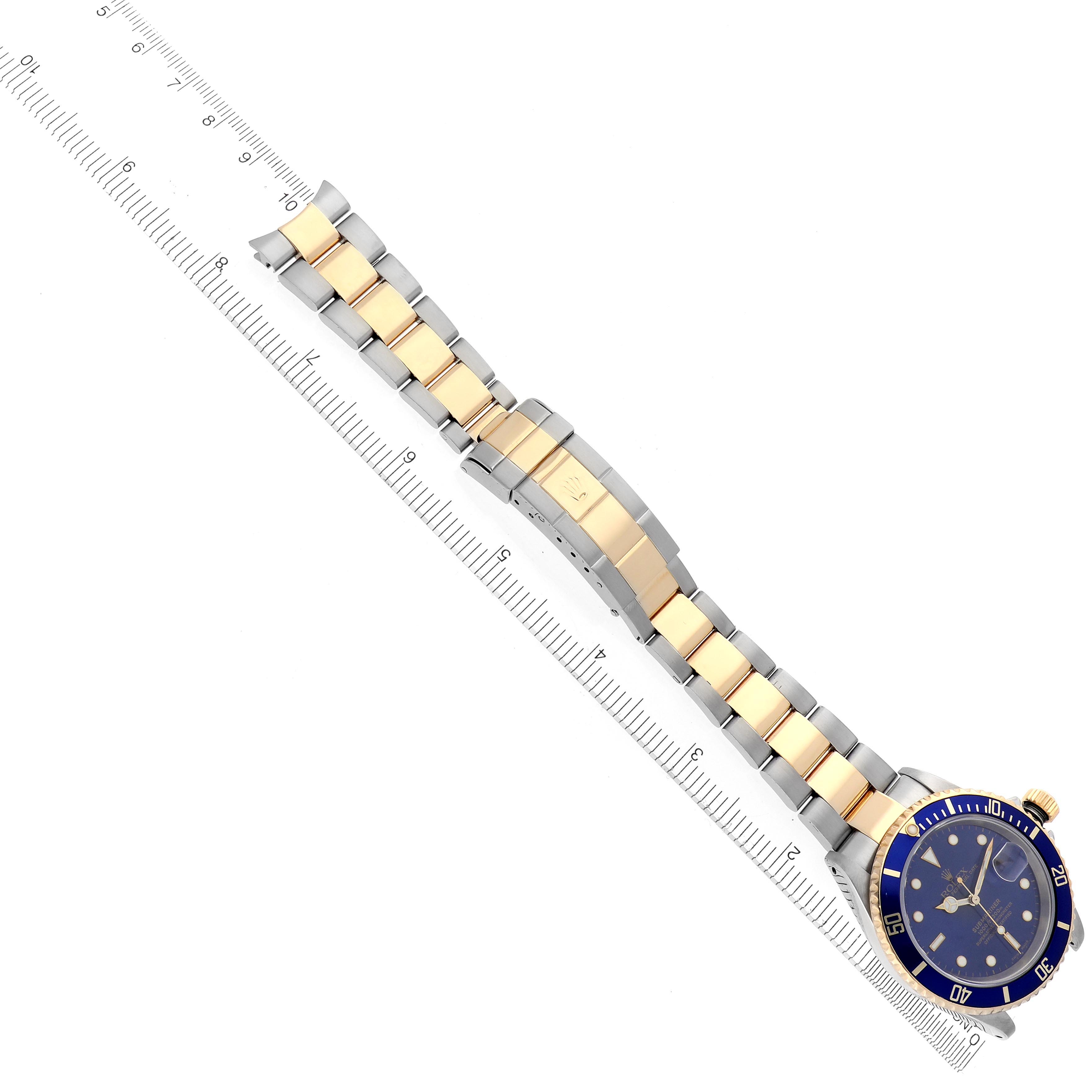 The Rolex Submariner 16613 Men's Steel and Gold (two tone) Blue Dial 16613 Men's Steel and Gold (two tone) Blue Dial is shown from an overhead view, highlighting the bracelet, clasp, bezel, and part of the face.