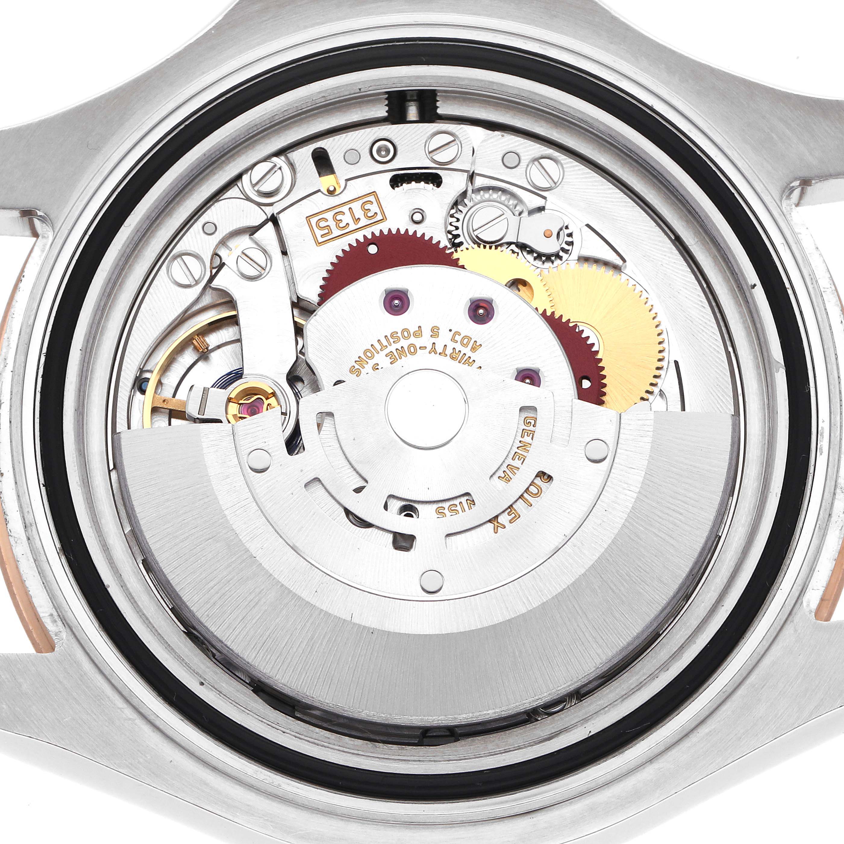 The image shows the internal mechanism of a Rolex Turn-o-Graph watch, focusing on gears and components from a top-down angle.