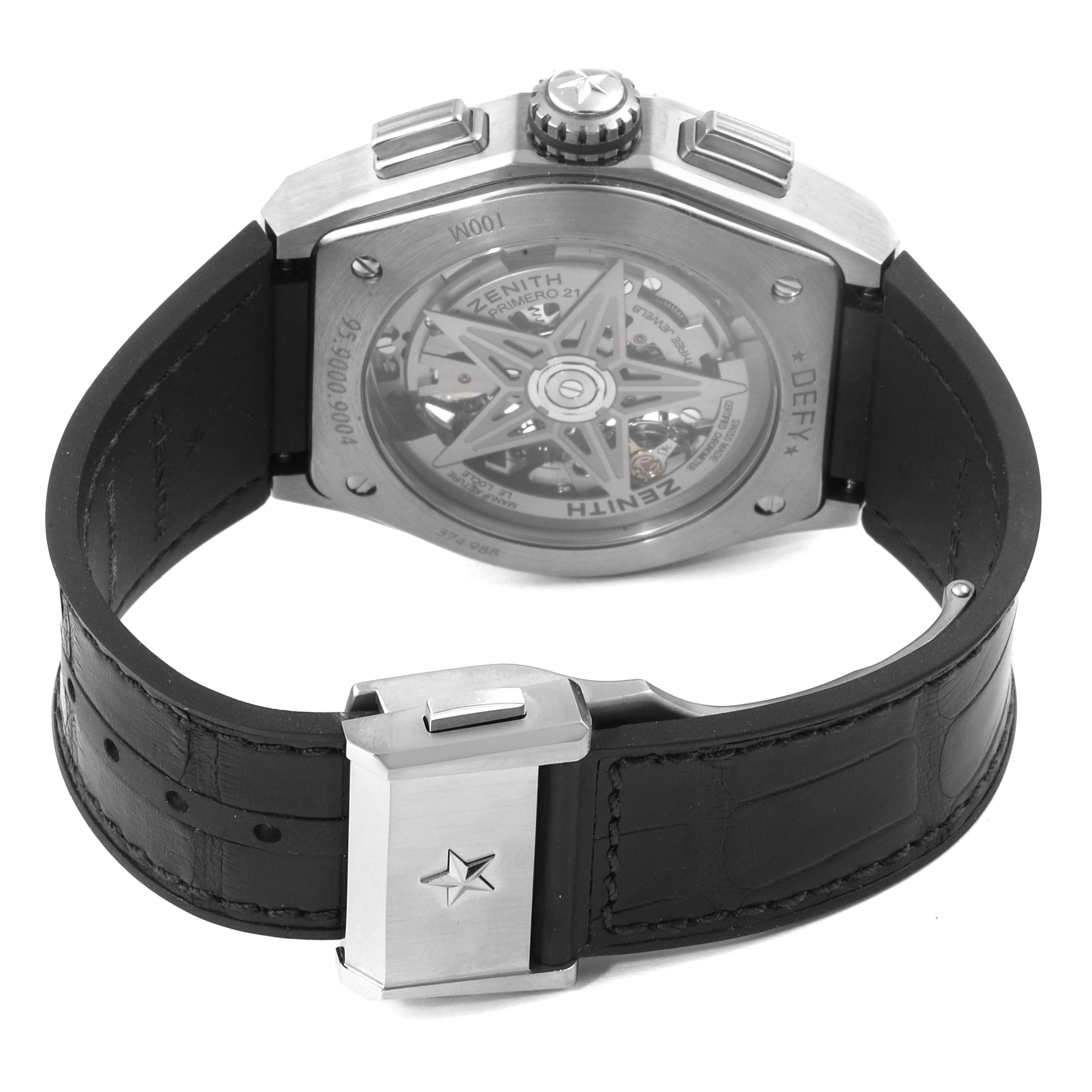 The image shows the back view of a Zenith Defy 95.9000.9004/78.M9000 Men's Titanium Grey Dial 95.9000.9004/78.M9000 Men's Titanium Grey Dial watch, highlighting its skeleton case back and black leather strap with a clasp.