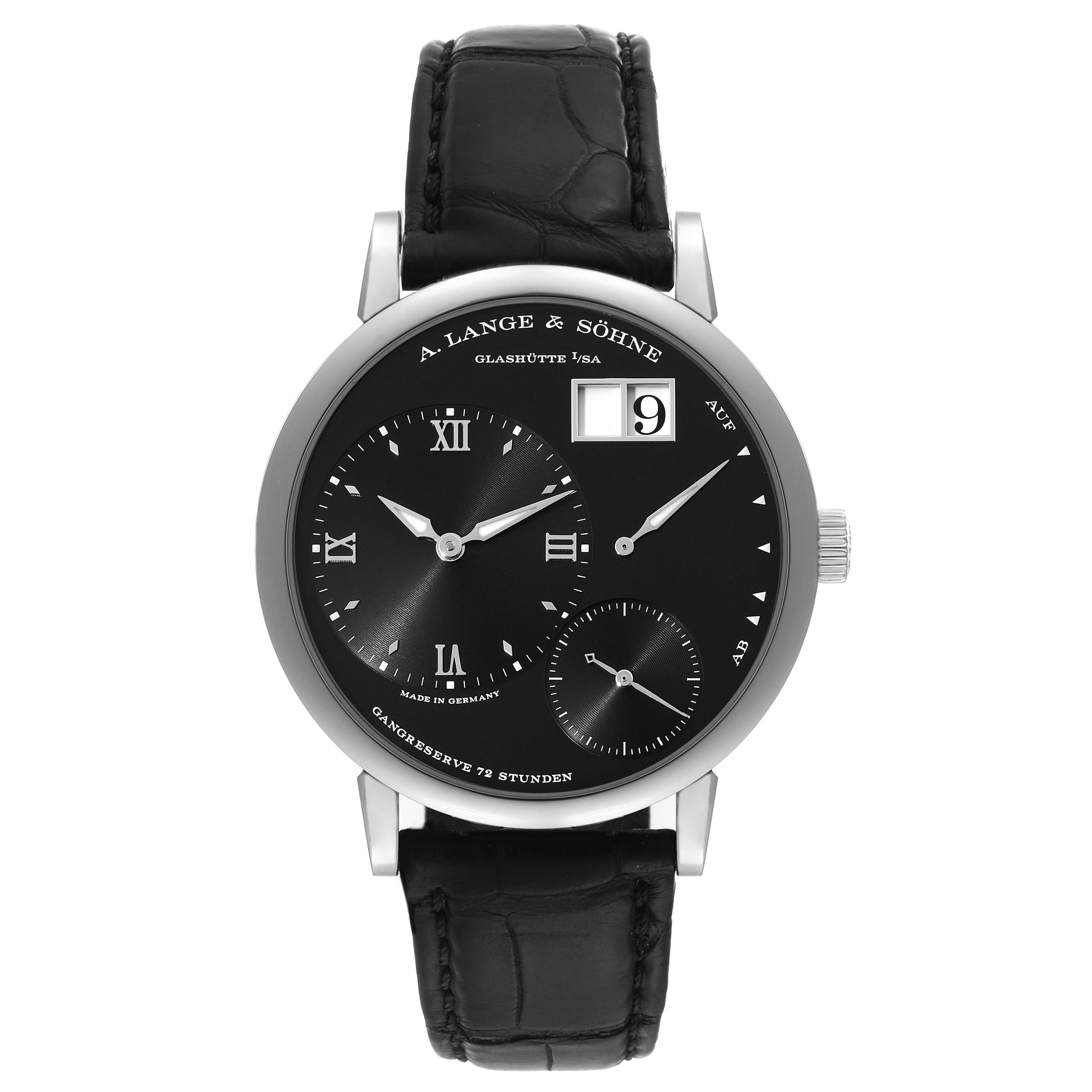 The image shows a front view of a Lange 1 model by A. Lange & Söhne, highlighting its black dial, subdials, and black leather strap.