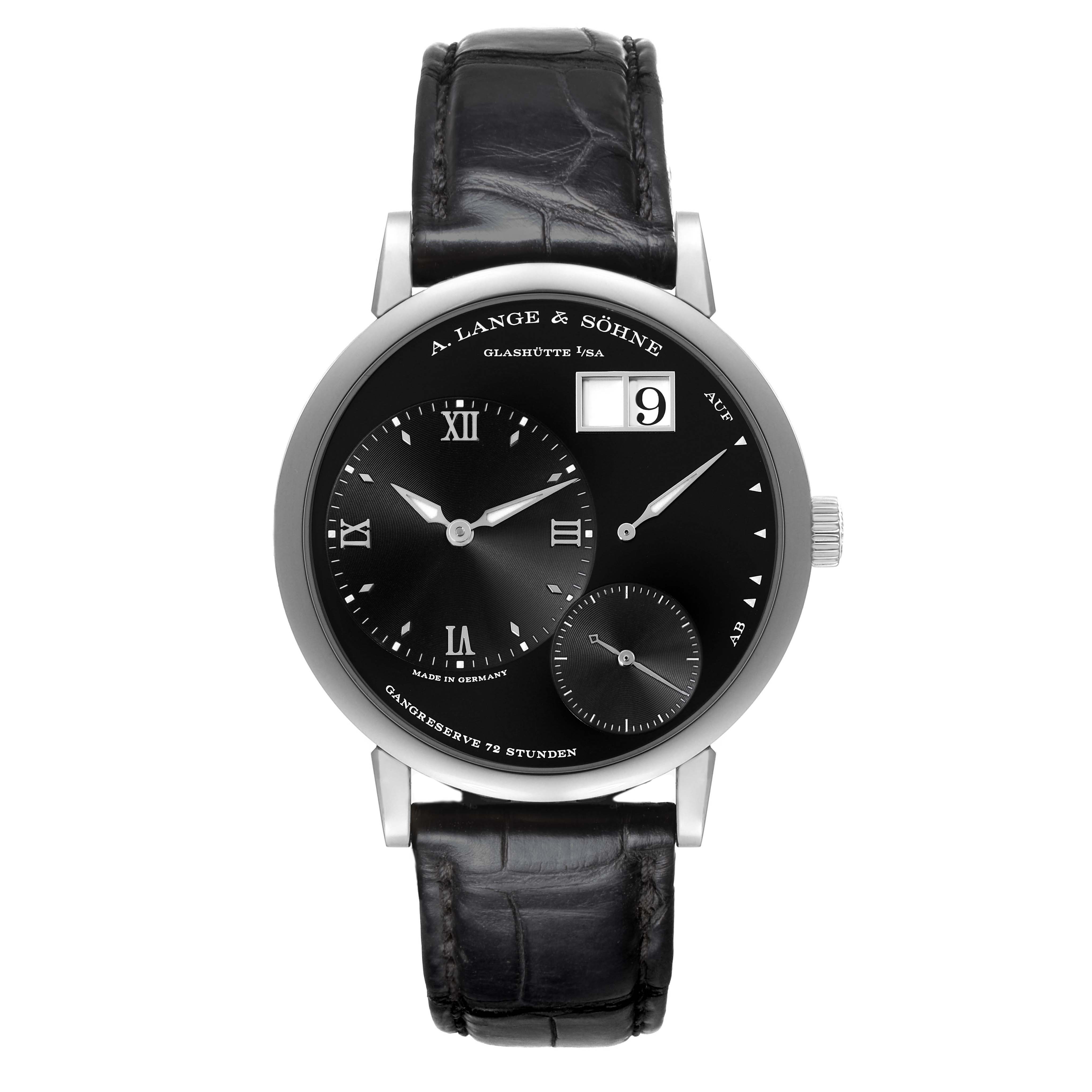 The A. Lange & Sohne Lange 1 117.028 Men's White Gold Black Dial watch is seen from the front, showing the black dial, sub-dials, date display, and leather strap.