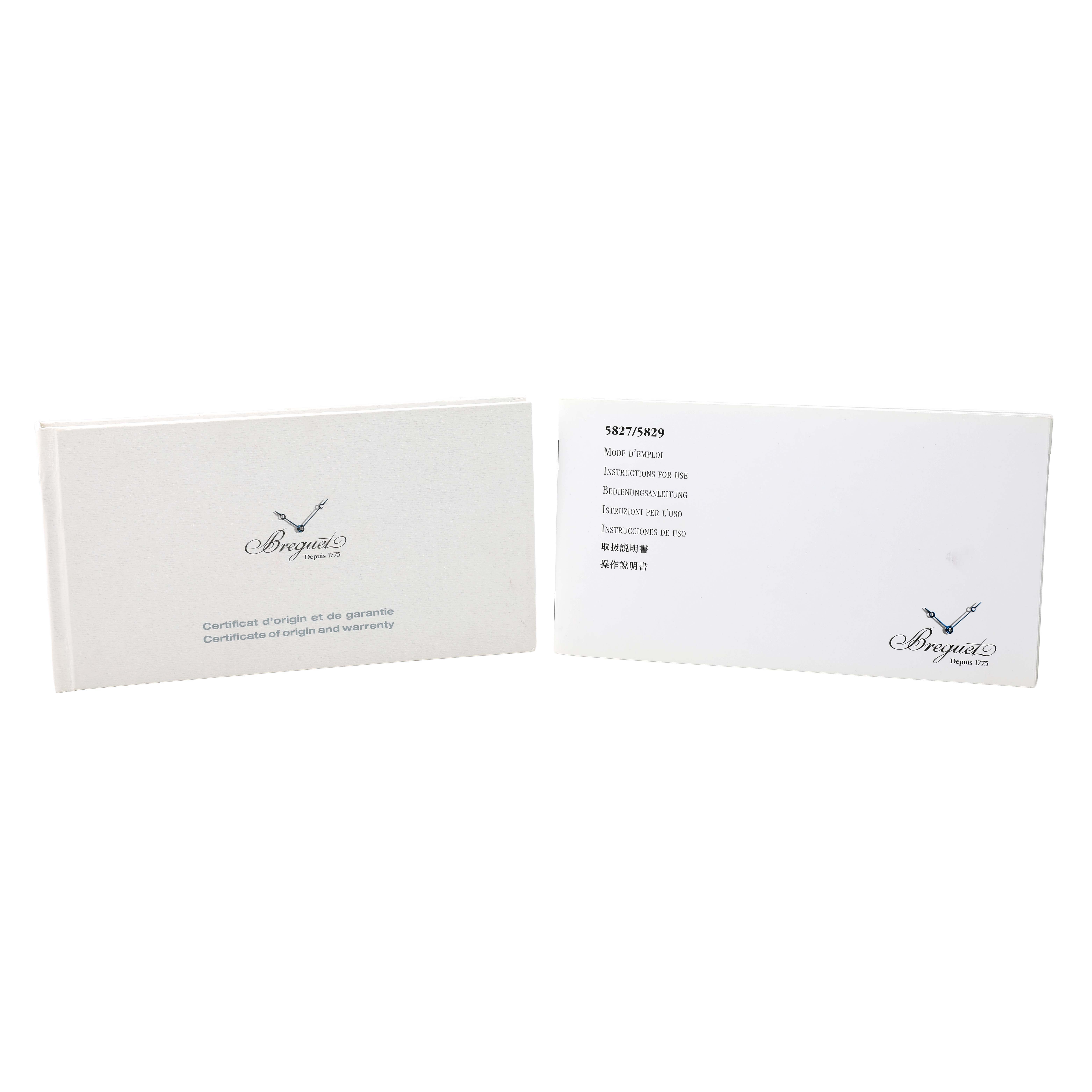 The image shows Breguet Marine 5827BR/Z2/5ZU Men's Yellow Gold Silver Dial model documentation, including certificates and instruction booklets displayed upright.