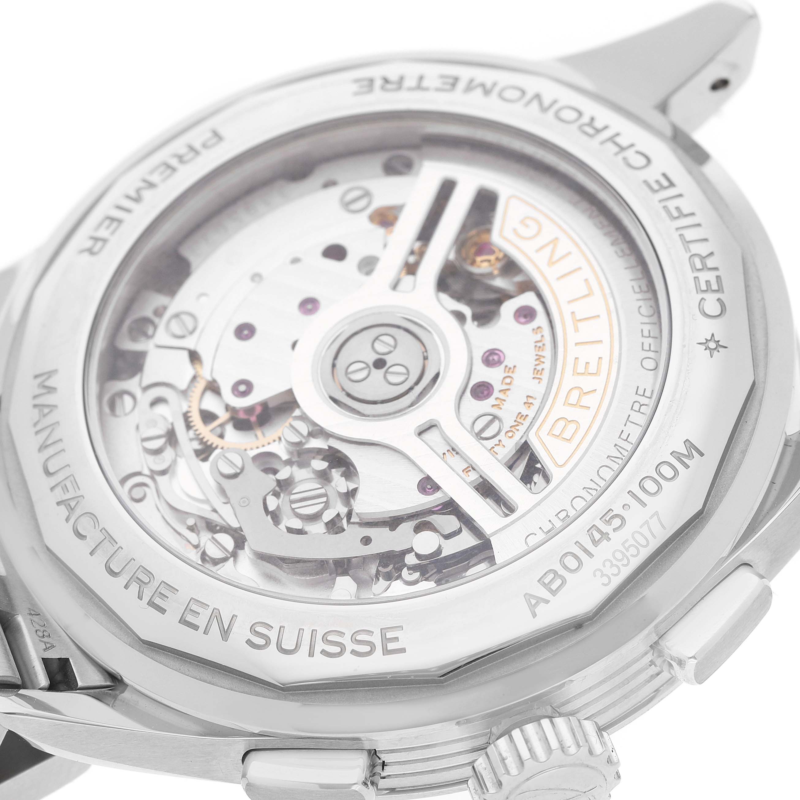 The image shows the case back of a Breitling Premier AB0145 Men's Stainless Steel Silver Dial watch, highlighting the movement and inscriptions on the metal rim.