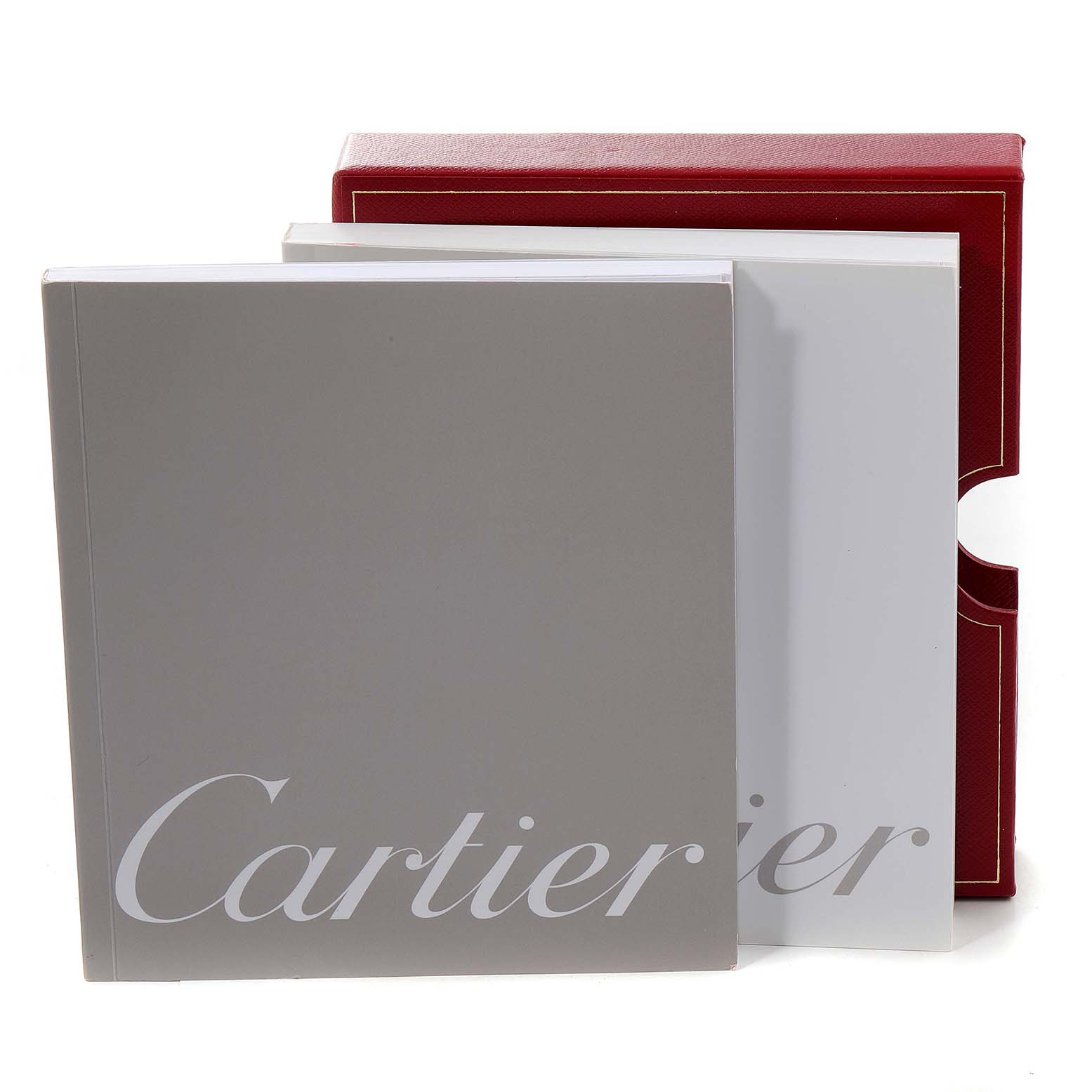 The image shows the packaging and documentation for a Ballon Bleu model by Cartier, featuring a red box, a white sleeve, and a grey booklet.