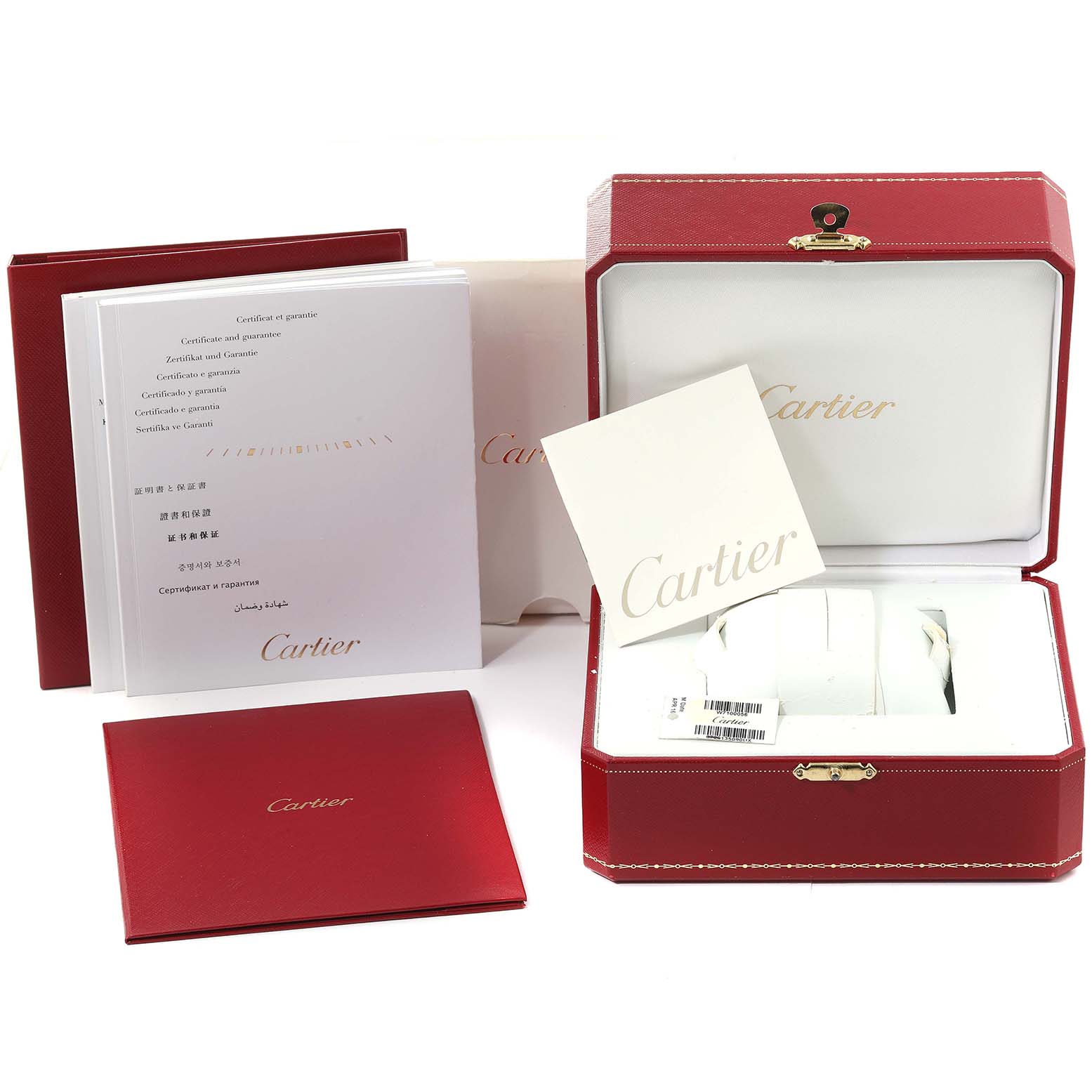 The image shows the packaging and accessories of a Calibre de Cartier watch by Cartier, including boxes, manuals, and tags.