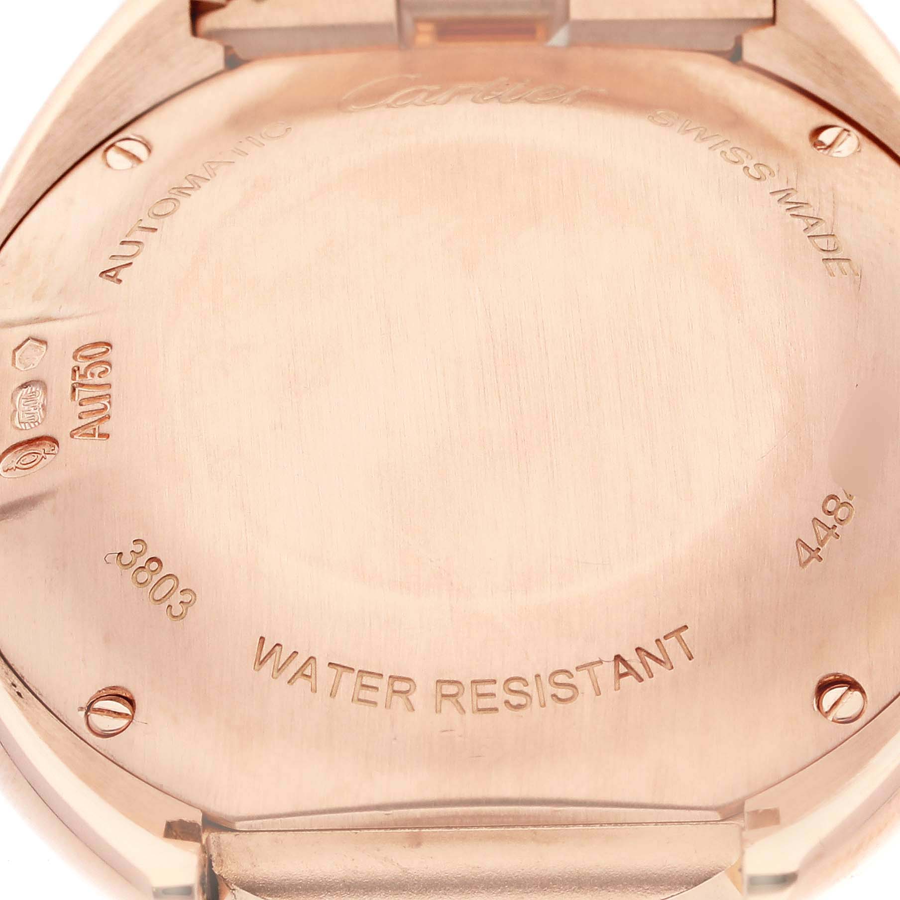 This image shows the case back of the Cle de Cartier watch, highlighting engravings and material details.