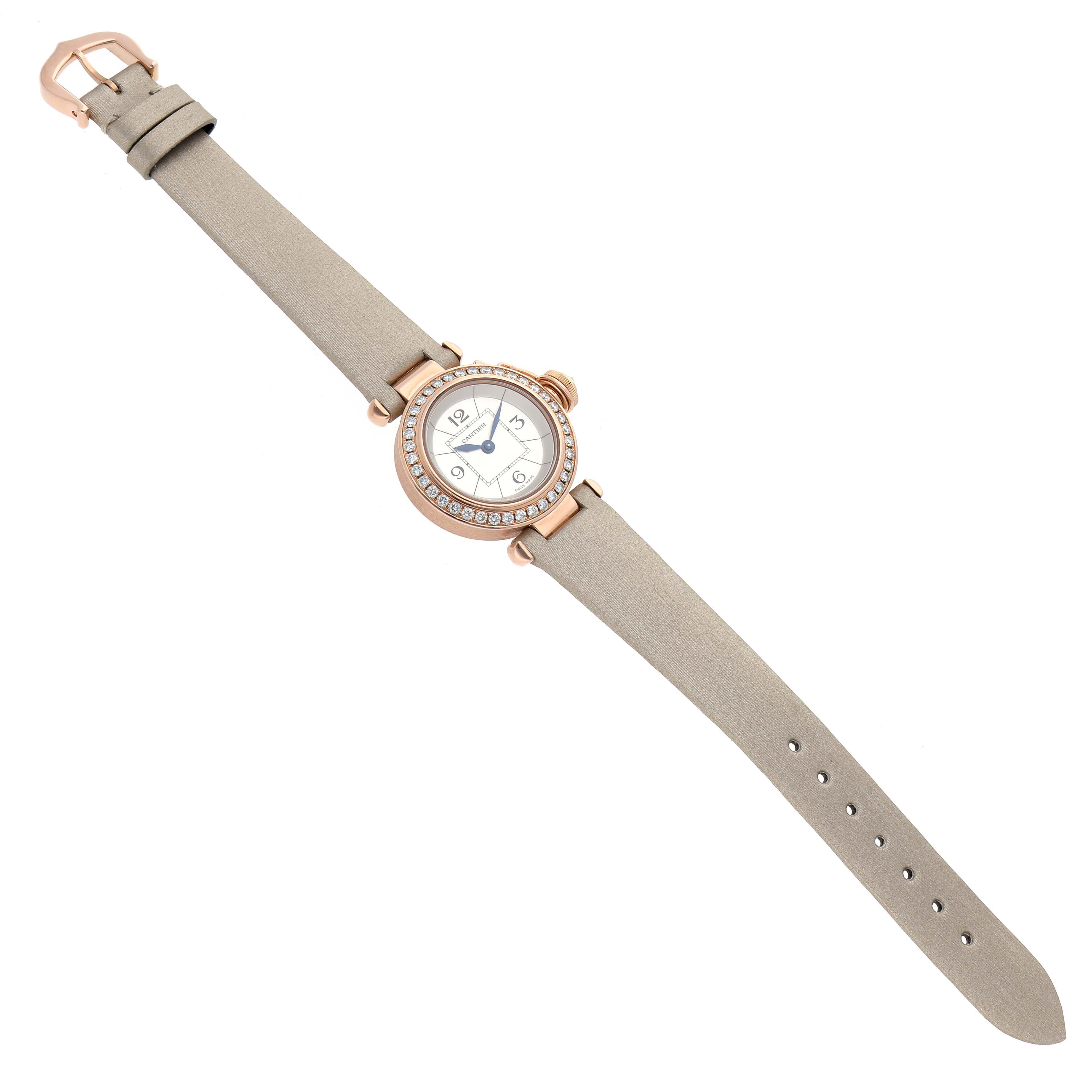 The Cartier Pasha WJ124026 Women's Rose Gold Silver Dial watch is shown from a top-down angle, featuring its face, bezel, and beige strap.
