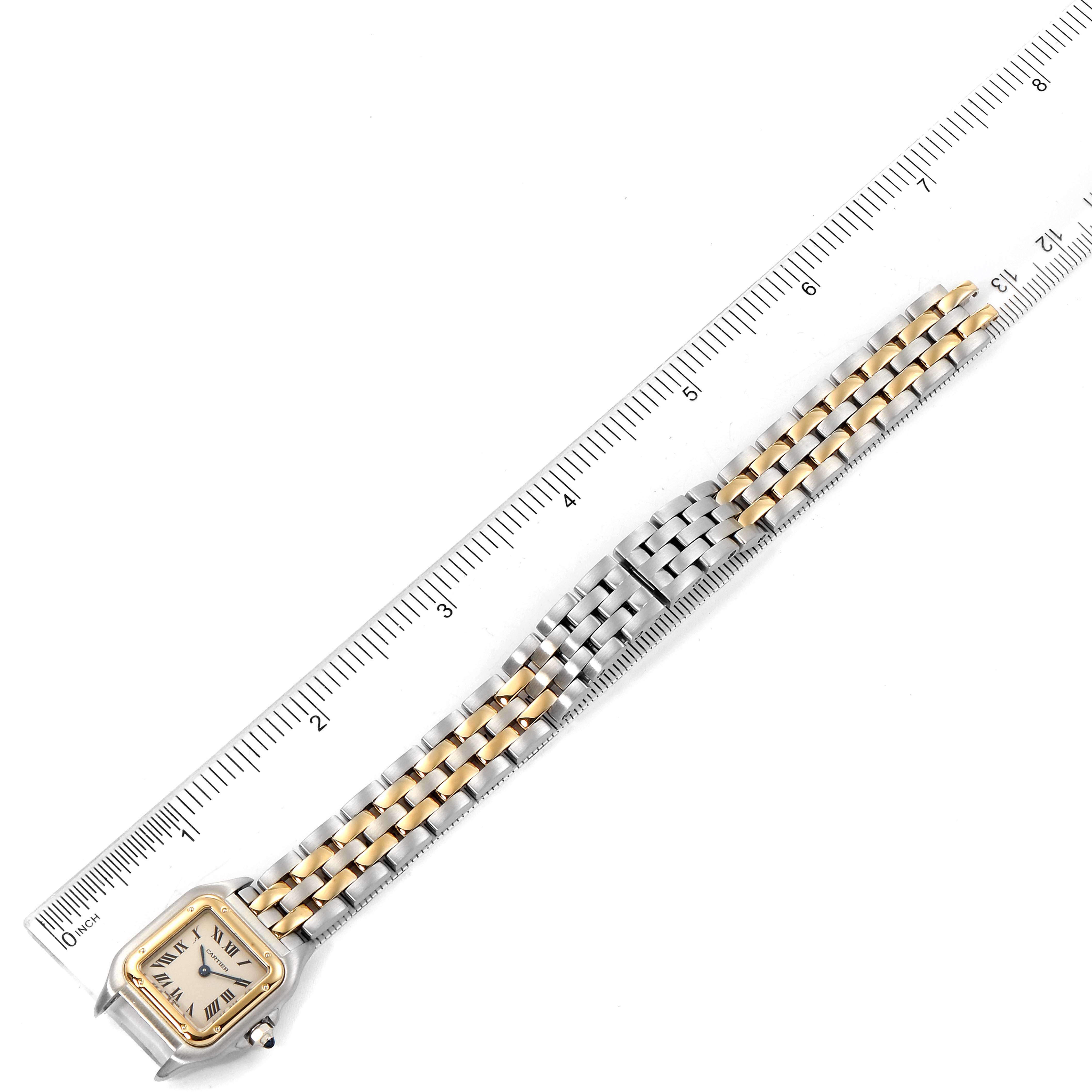 The image shows a Panthere model by Cartier, positioned vertically next to a ruler, displaying the watch face and entire two-tone bracelet.