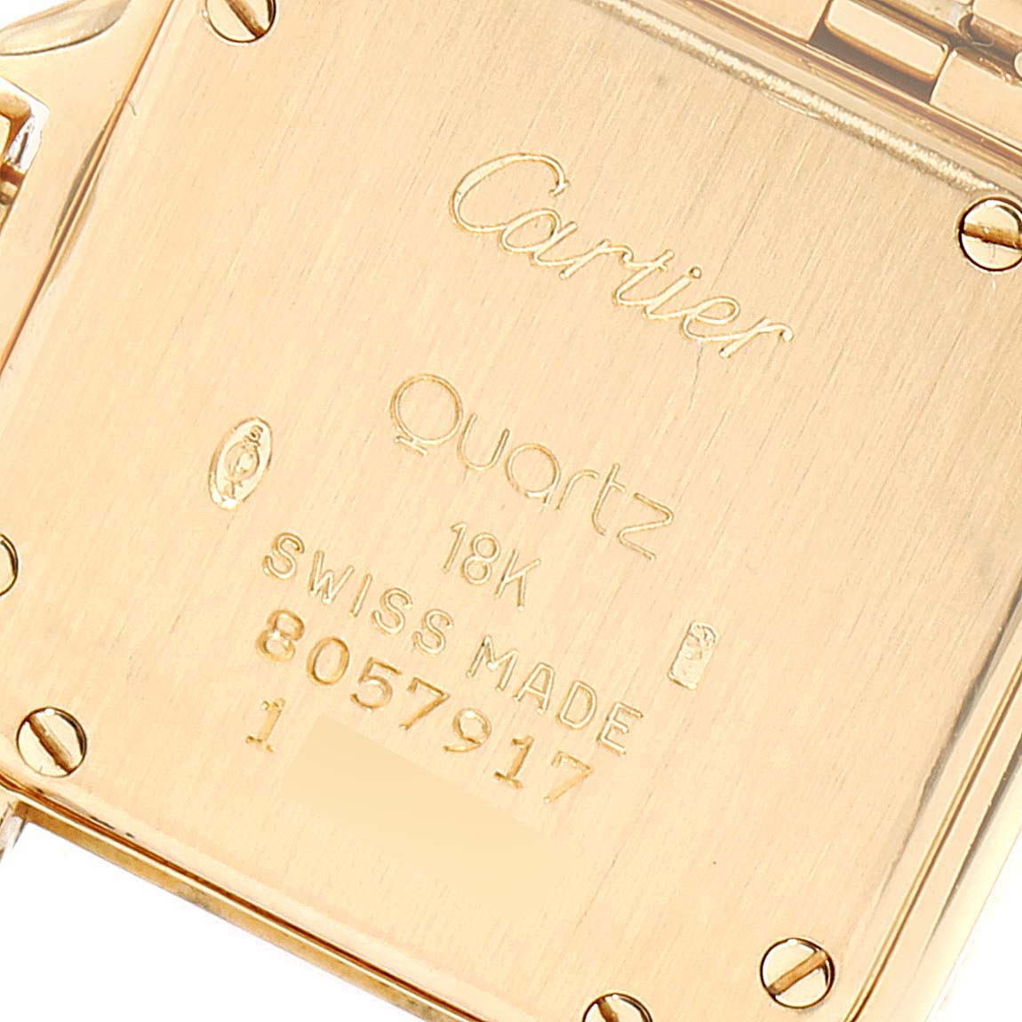 The image shows the back case of a Cartier Panthere W25022B9 Women's Yellow Gold Silver Dial W25022B9 Women's Yellow Gold Silver Dial model watch with engravings and serial number.