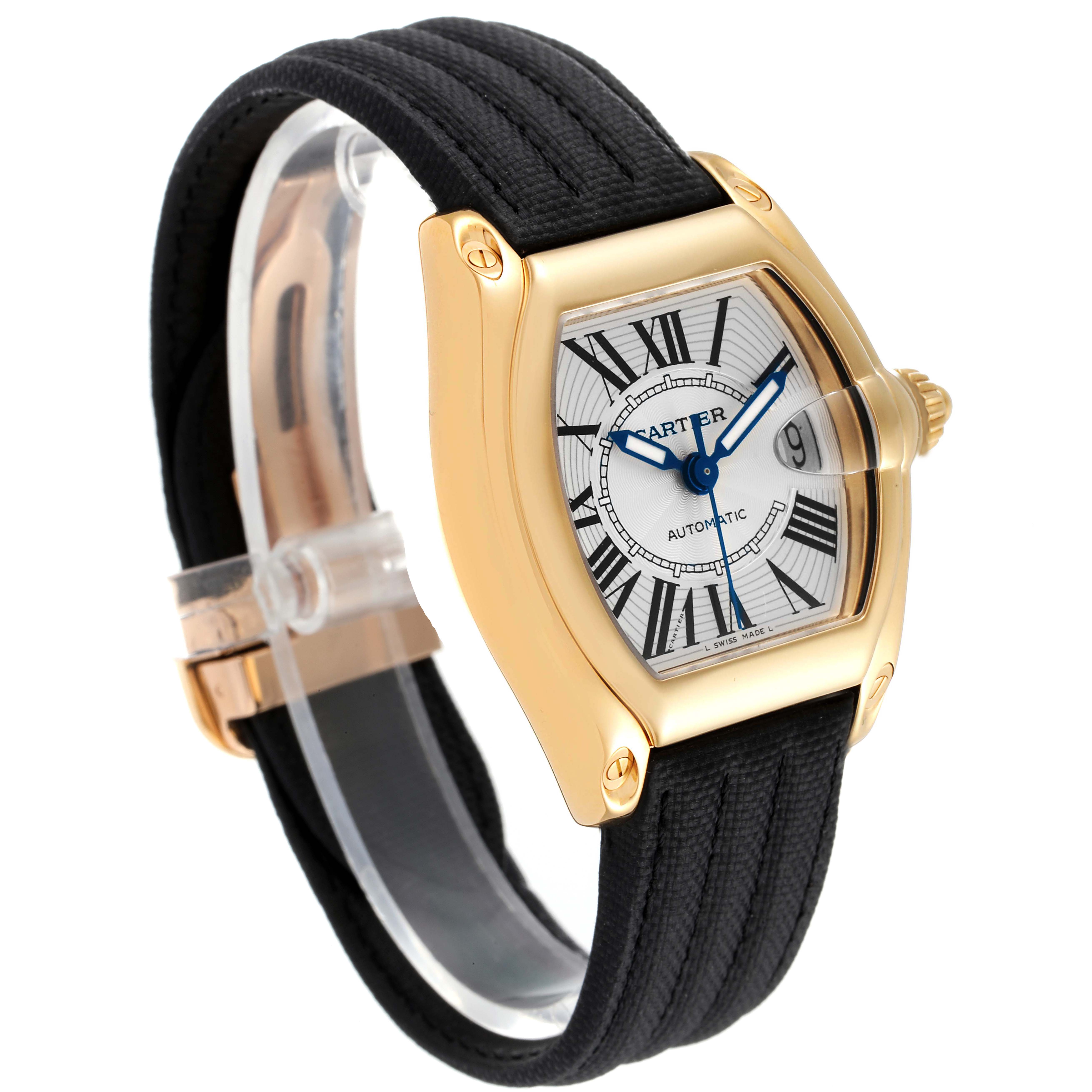 The Cartier Roadster W62005V2 Men's Yellow Gold Silver Dial W62005V2 Men's Yellow Gold Silver Dial watch is shown in a close-up, angled view highlighting its face, bezel, and black strap.