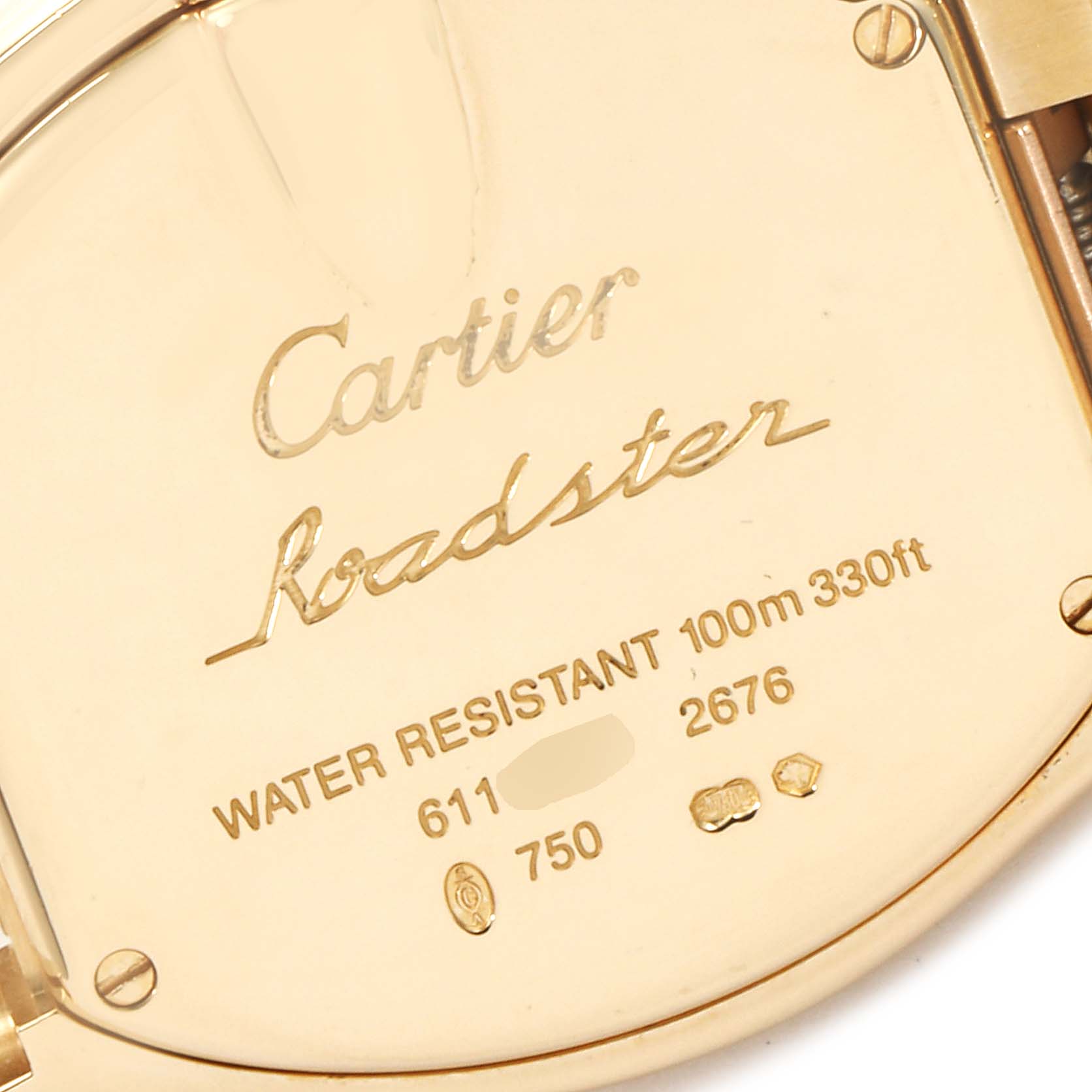 The image shows a close-up view of the case back of the Cartier Roadster W62018V1 Women's Yellow Gold Silver Dial W62018V1 Women's Yellow Gold Silver Dial watch, highlighting engravings and water resistance information.