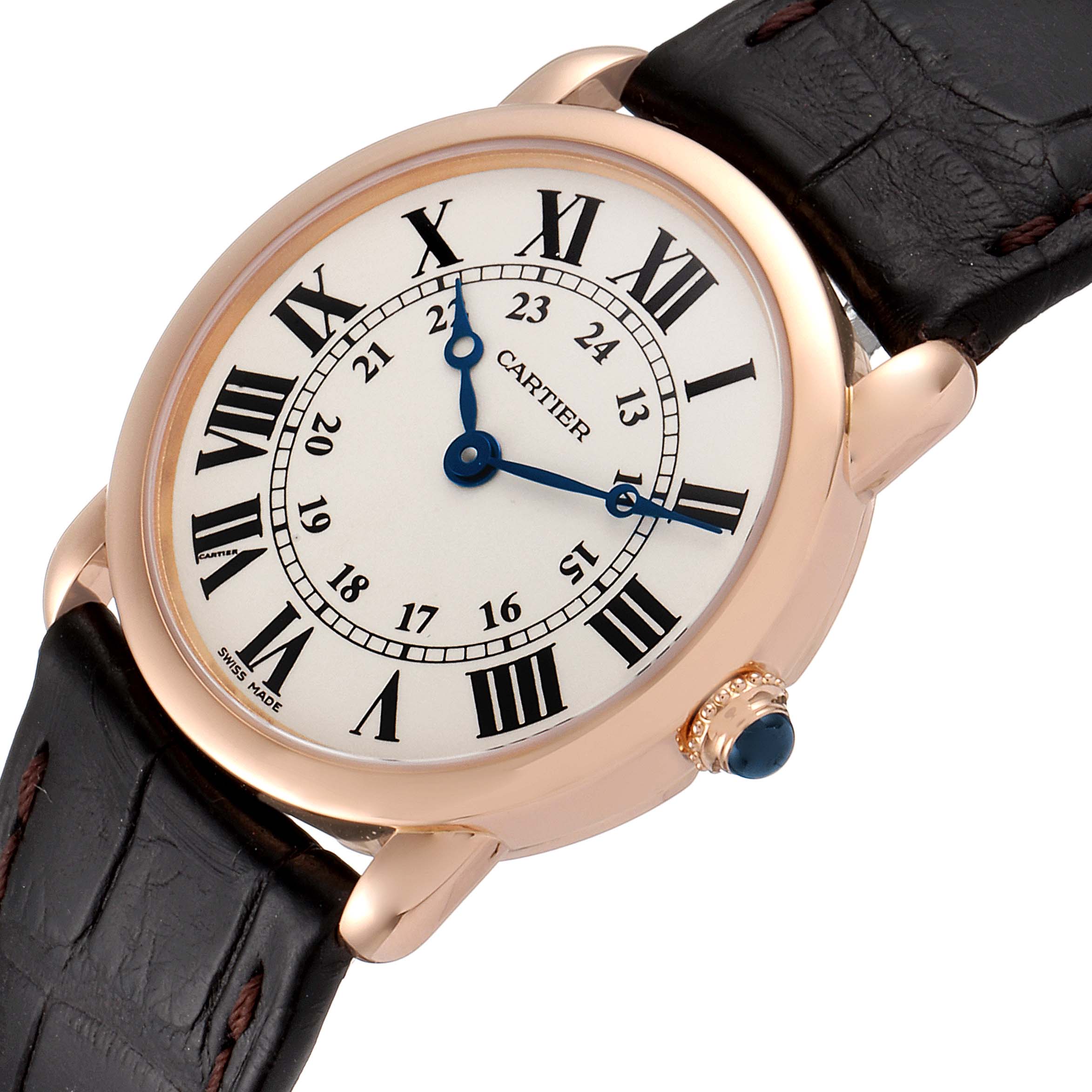 The Cartier Ronde W6800151 Women's Rose Gold Silver Dial W6800151 Women's Rose Gold Silver Dial watch is shown from a three-quarter angle, displaying the face, leather strap, and crown with a blue cabochon.