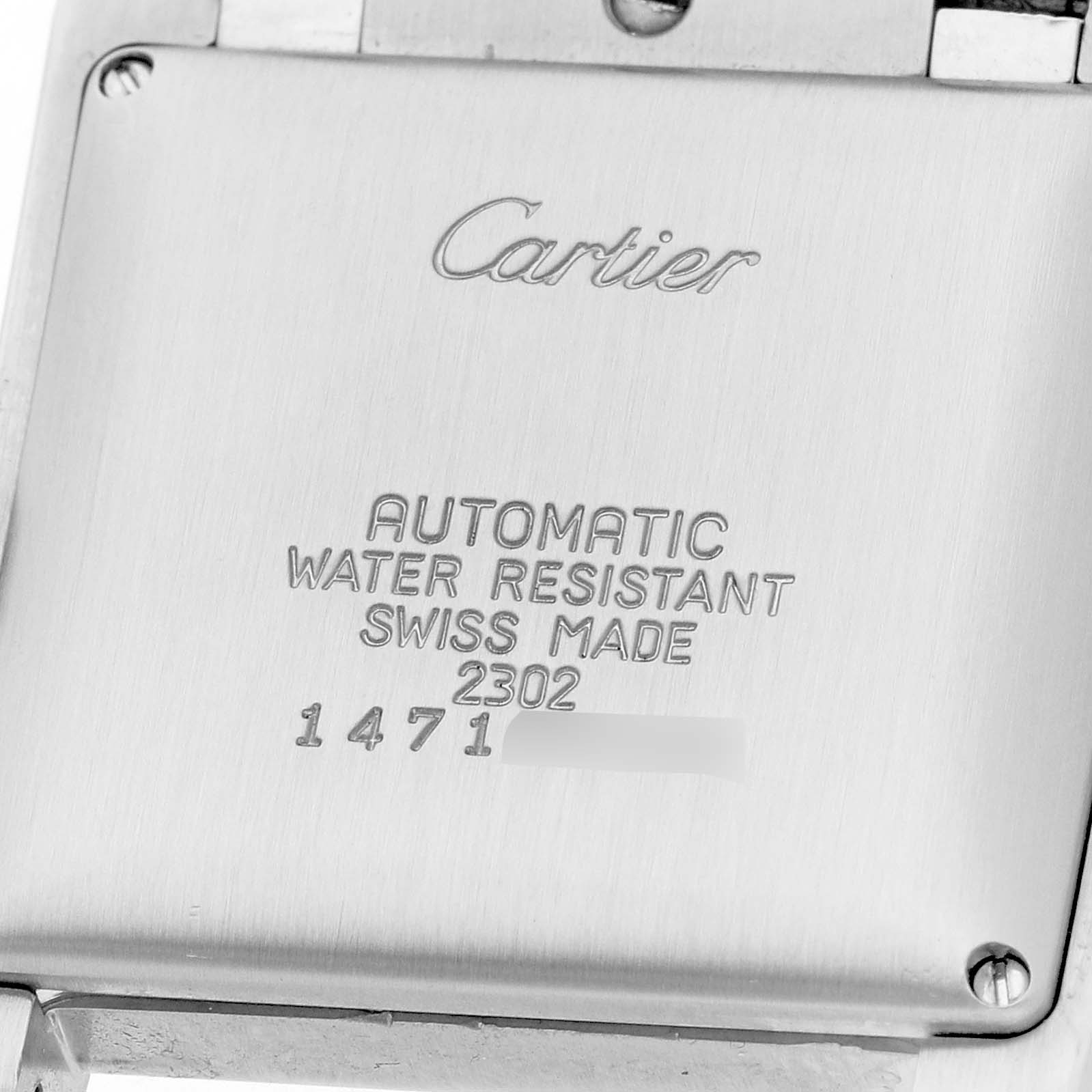 This image shows the back case of a Cartier Tank Française watch, highlighting engraved details like water resistance and serial numbers.