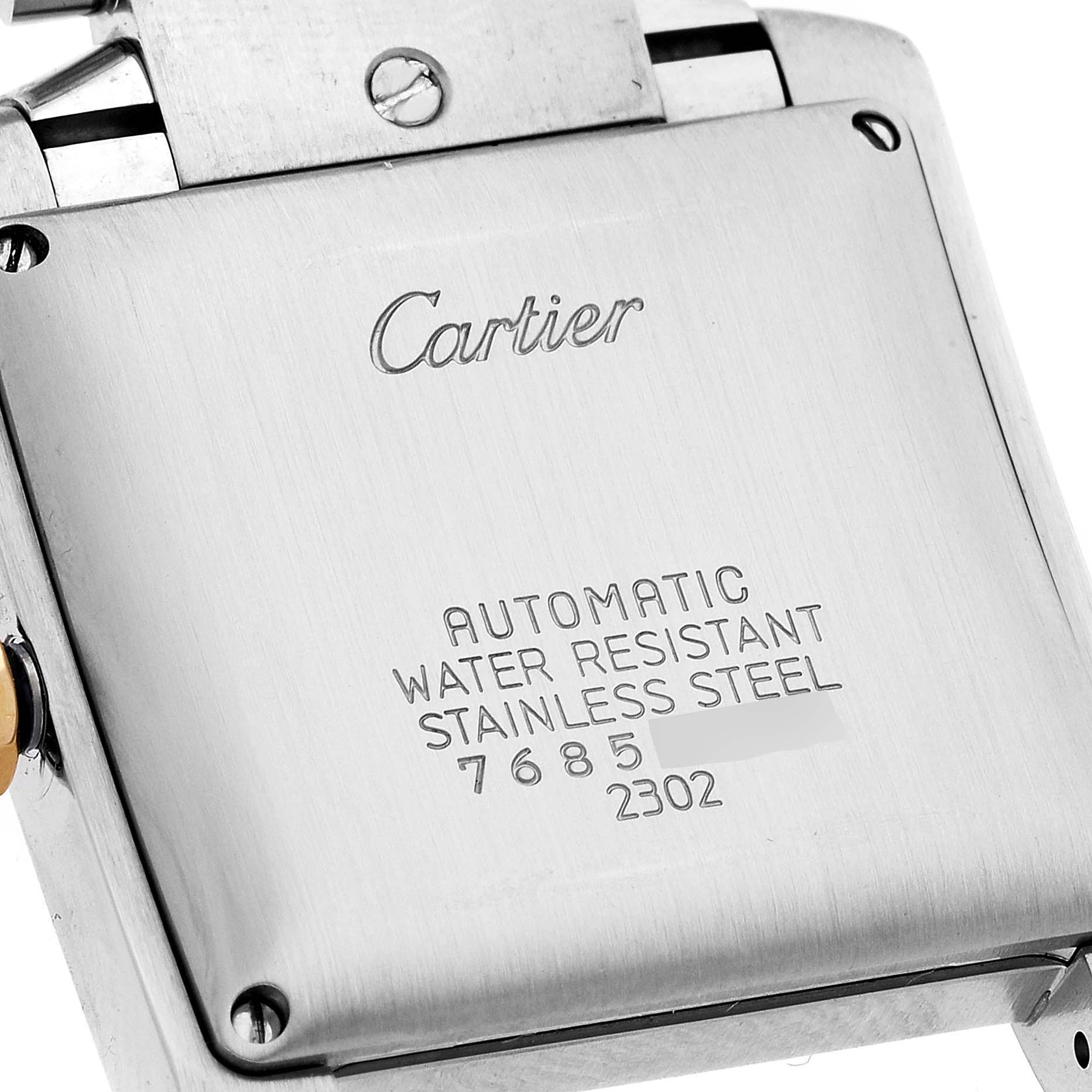 The image shows the back case of the Cartier Tank Française watch, highlighting its engravings and stainless steel construction.
