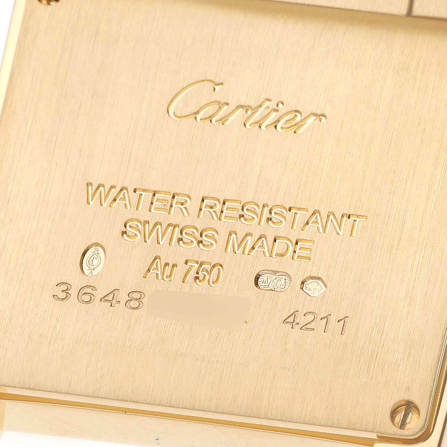 The image shows the back case of a Cartier Tank Francaise WJTA0025 Women's Yellow Gold Silver Dial WJTA0025 Women's Yellow Gold Silver Dial watch, highlighting its inscriptions and hallmark details.