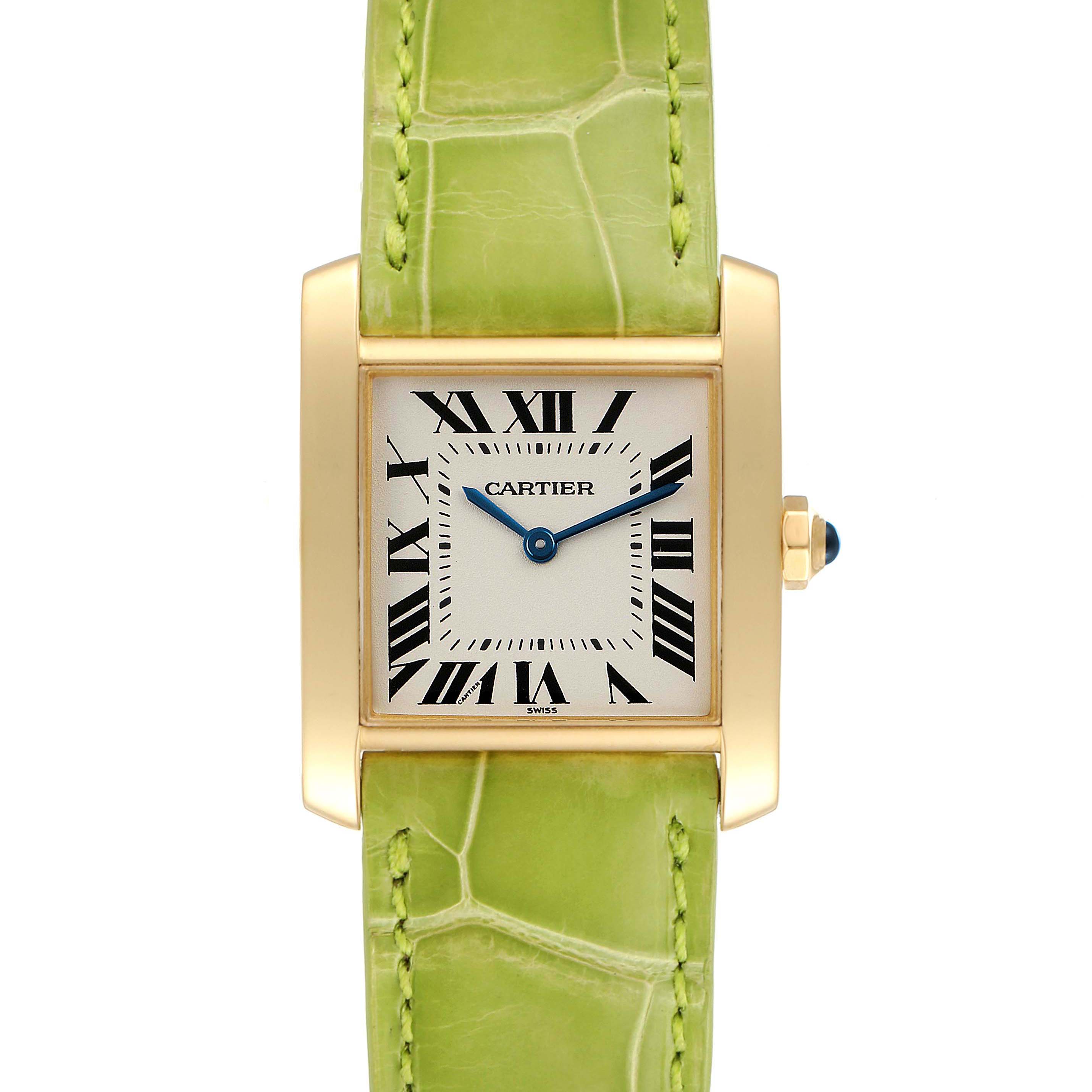 The image shows a front view of a Cartier Tank Francaise W5000356 Women's Yellow Gold Silver Dial W5000356 Women's Yellow Gold Silver Dial watch, highlighting its green strap and gold rectangular case.
