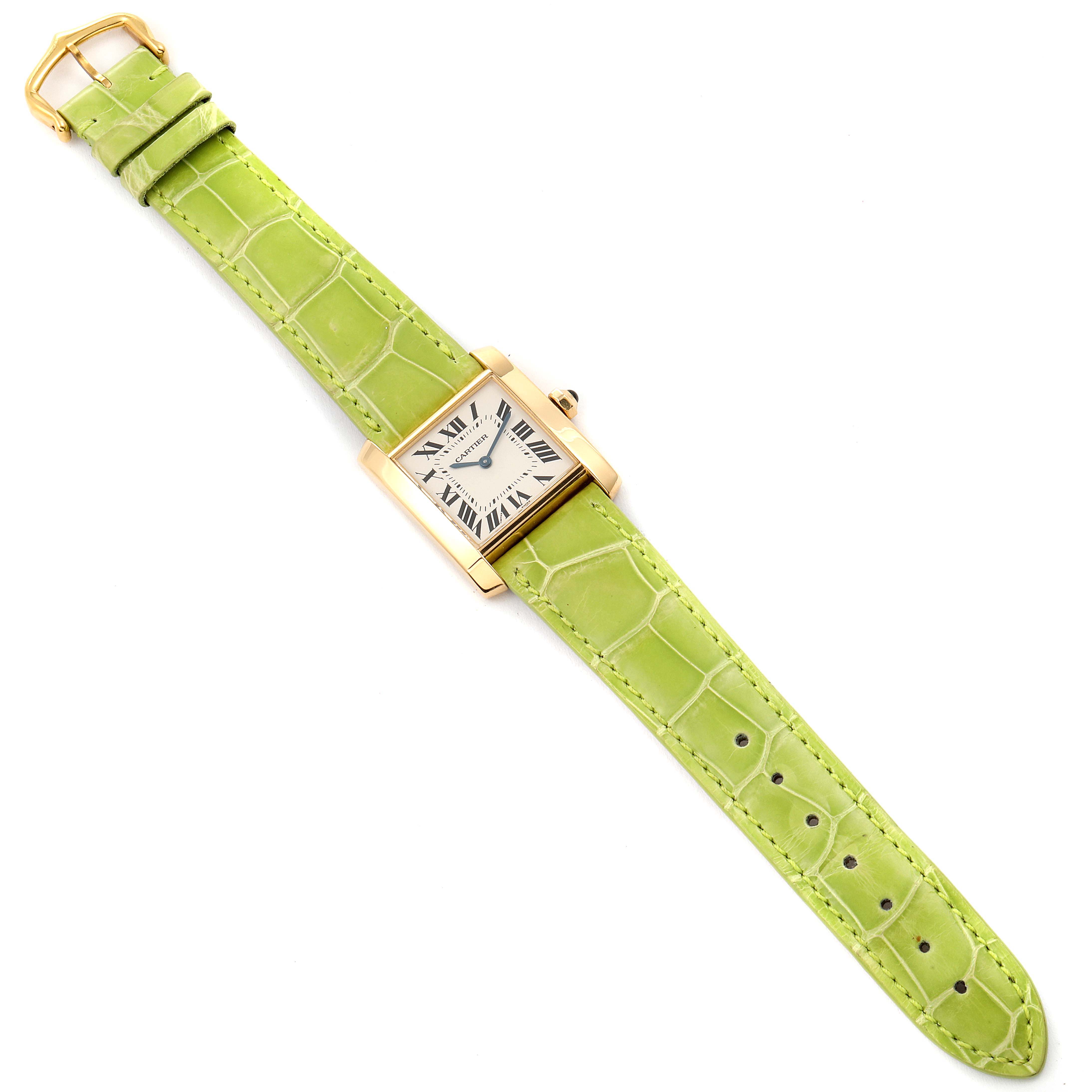 The Cartier Tank Francaise W5000356 Women's Yellow Gold Silver Dial W5000356 Women's Yellow Gold Silver Dial watch is shown from a top-down angle, featuring its rectangular face and green leather strap.