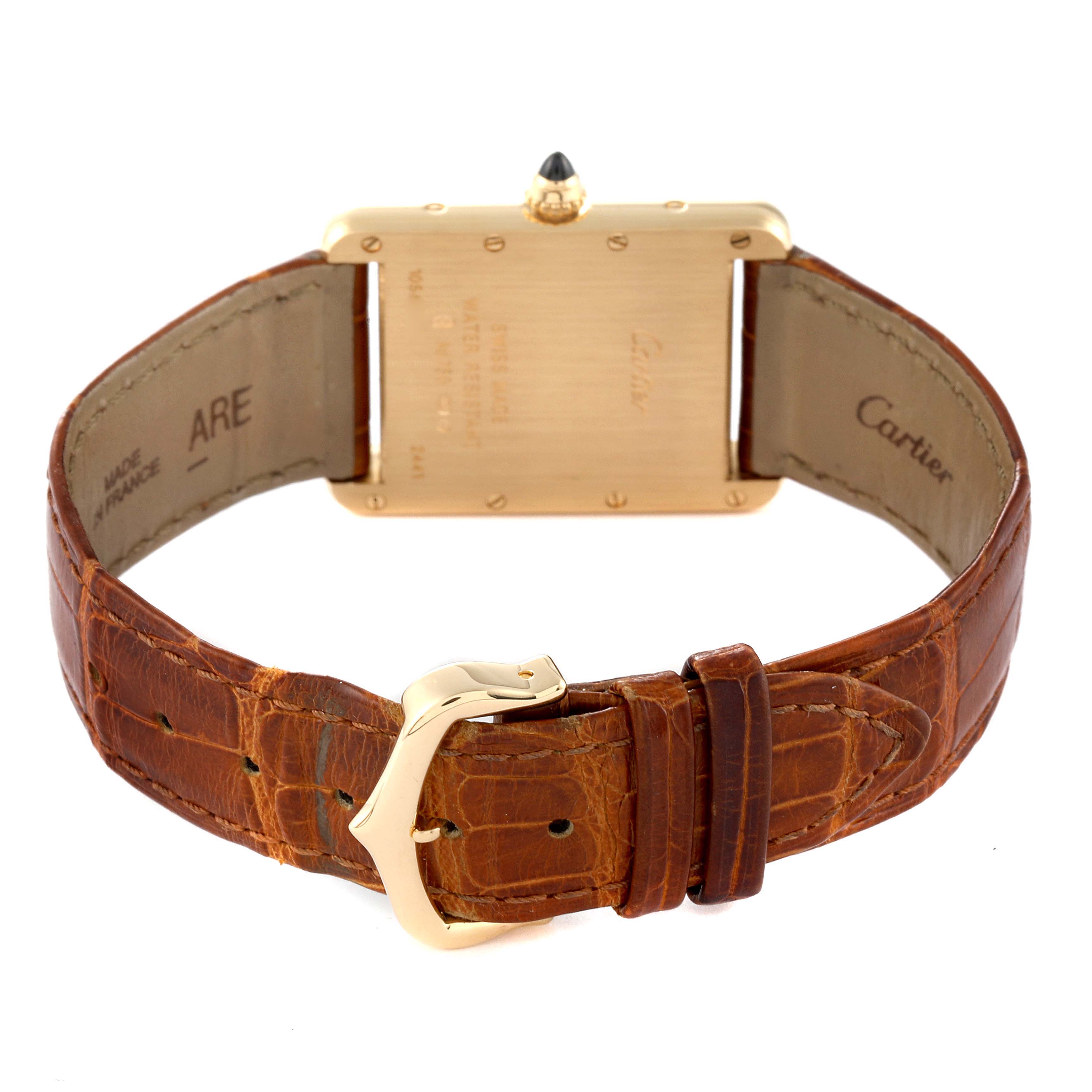 The image shows the back of a Cartier Tank Louis W1529756 Men
s Yellow Gold Silver Dial W1529756 Men
s Yellow Gold Silver Dial watch with its brown leather strap and gold clasp.