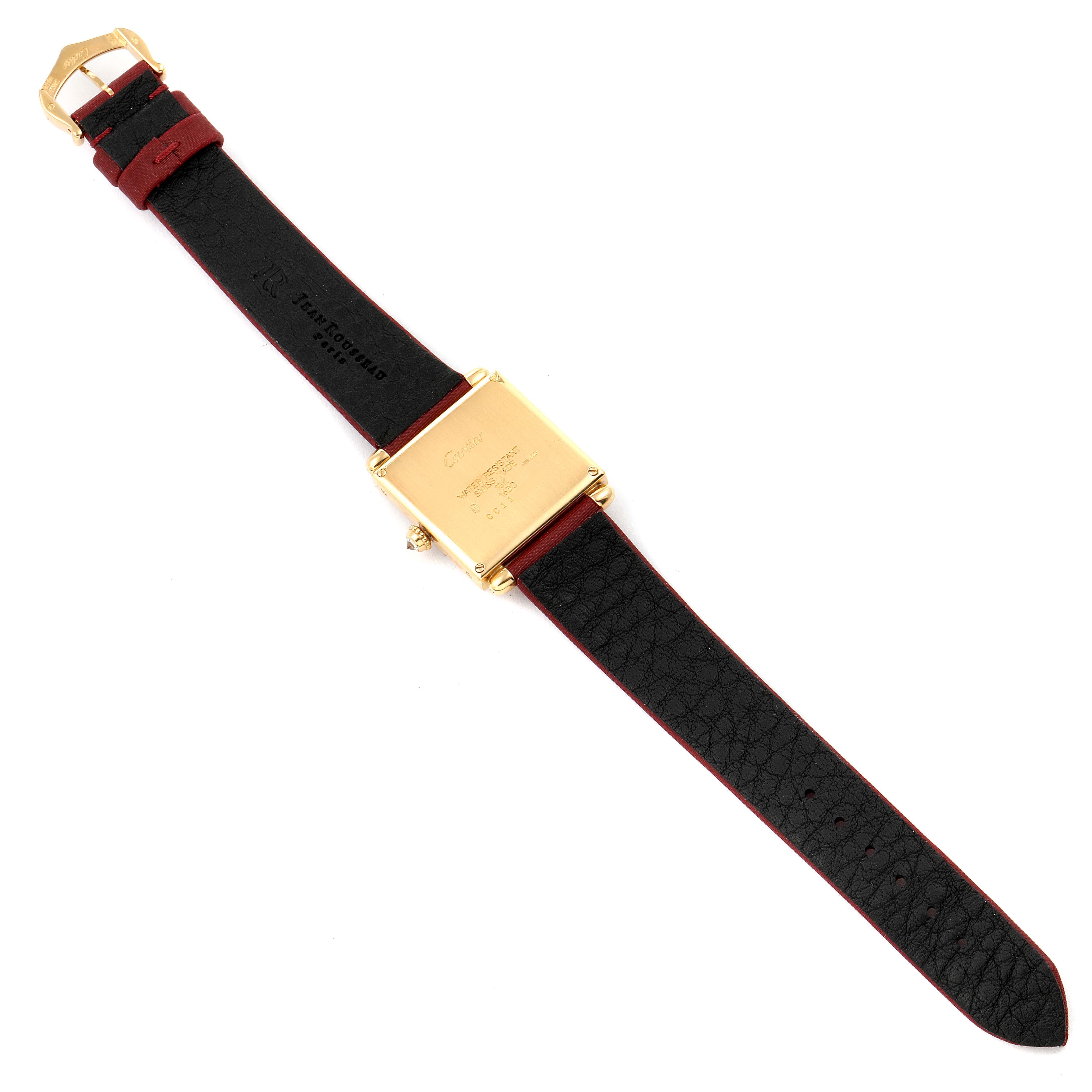 The image shows the back view of a Cartier Tank Obus WB800351  Women's Yellow Gold Silver Dial WB800351  Women's Yellow Gold Silver Dial watch, including its leather strap and gold case.