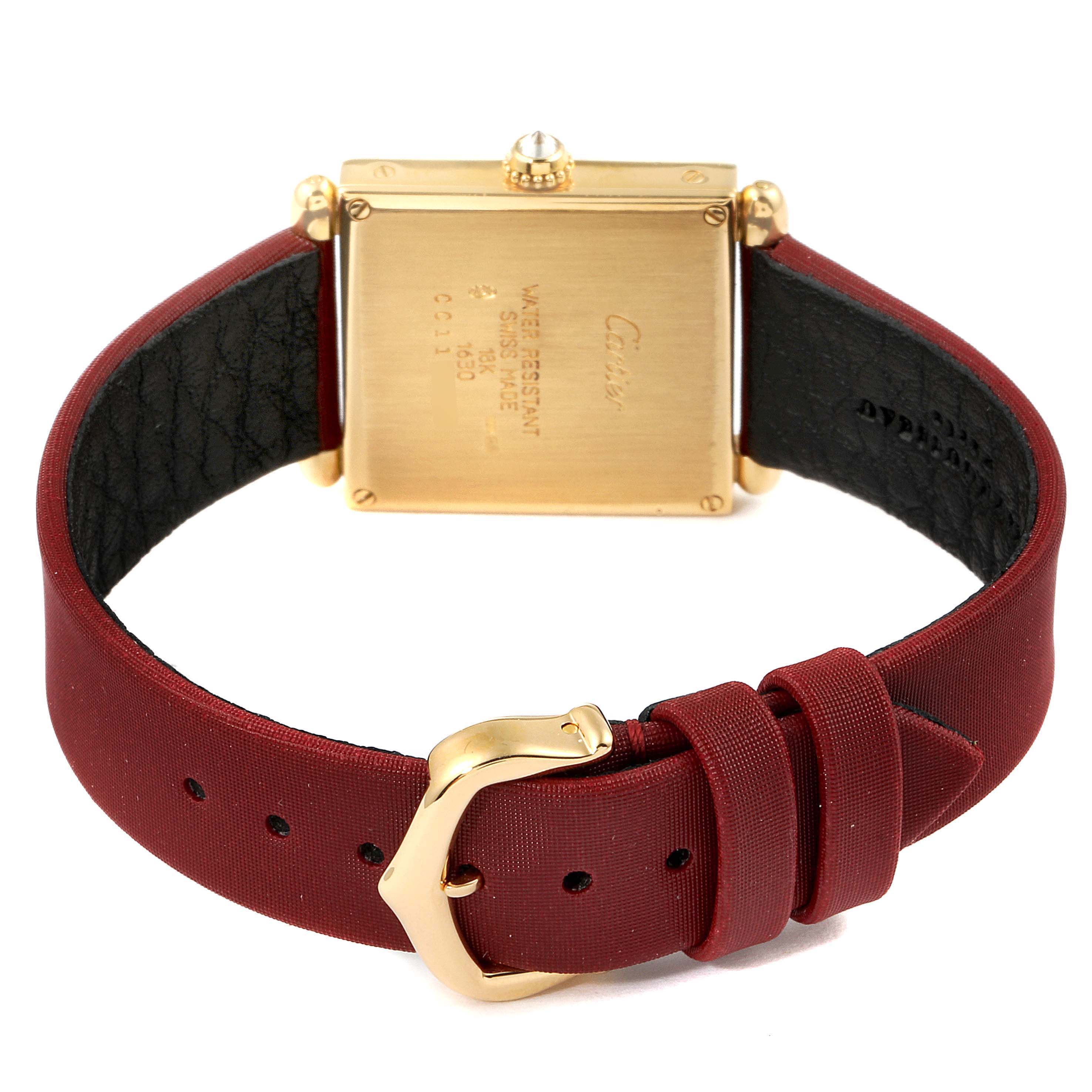 This image shows the back view of a Cartier Tank Obus WB800351  Women's Yellow Gold Silver Dial WB800351  Women's Yellow Gold Silver Dial watch, highlighting its gold case, red strap, and buckle.